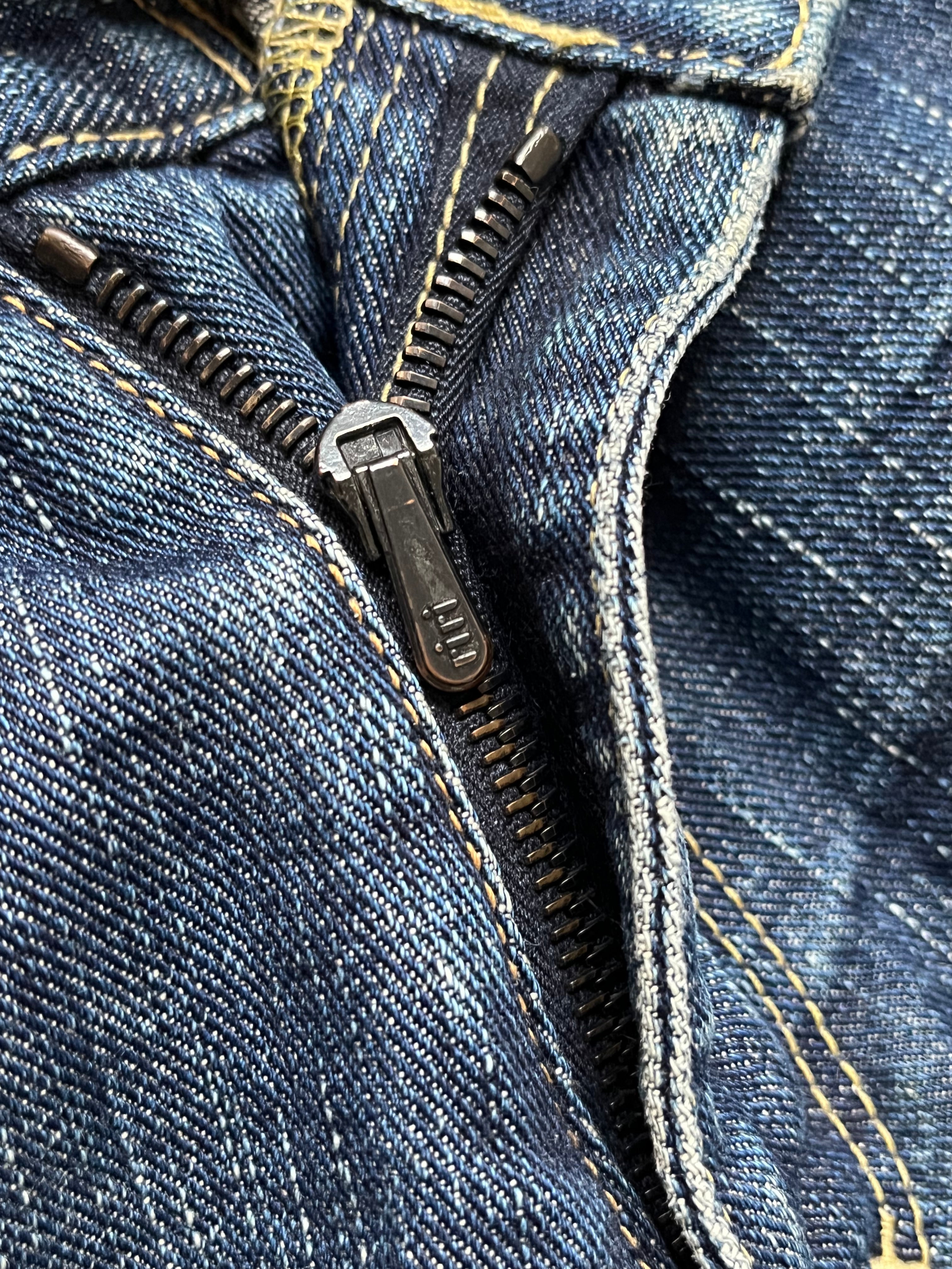 Number (N)ine SS05 Nightcrawler distressed denim pants with ripped details and relaxed fit, displayed on a neutral background.