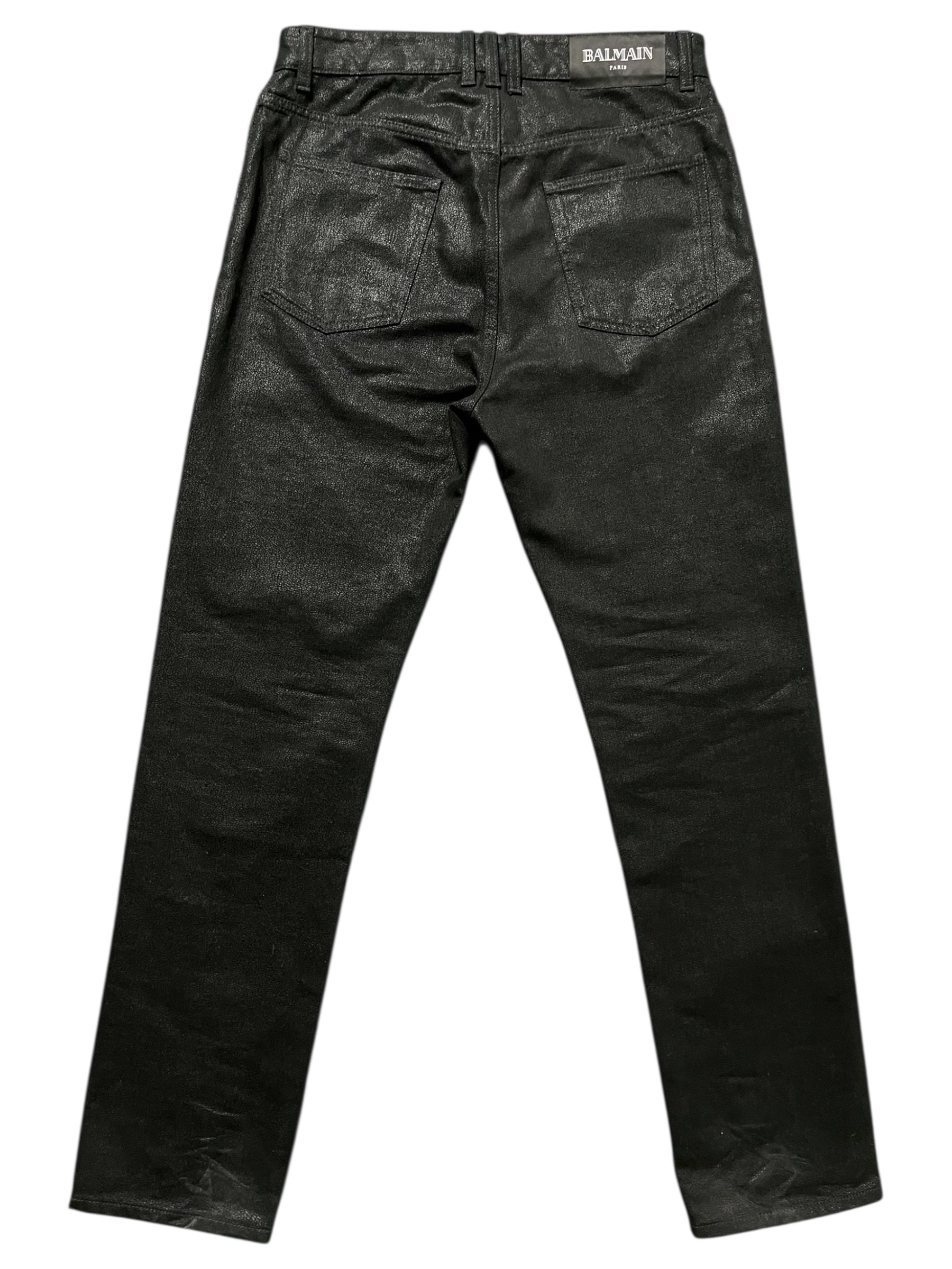 Balmain AW23 limited edition waxed denim pants, close-up showing textured fabric and stylish stitching.