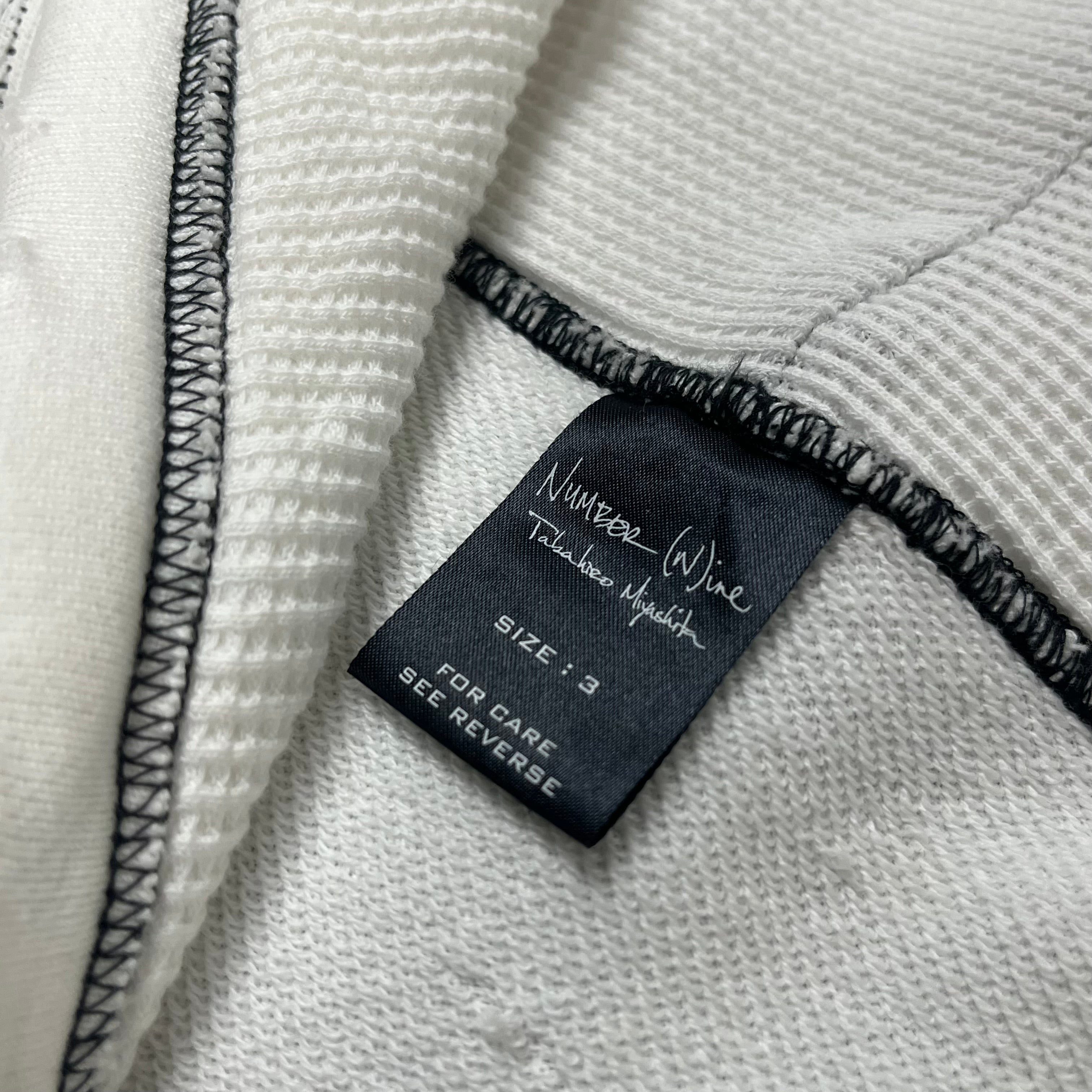 Number (N)ine SS05 Nightcrawler asymmetrical zip-up jacket with black fabric and unique design details.