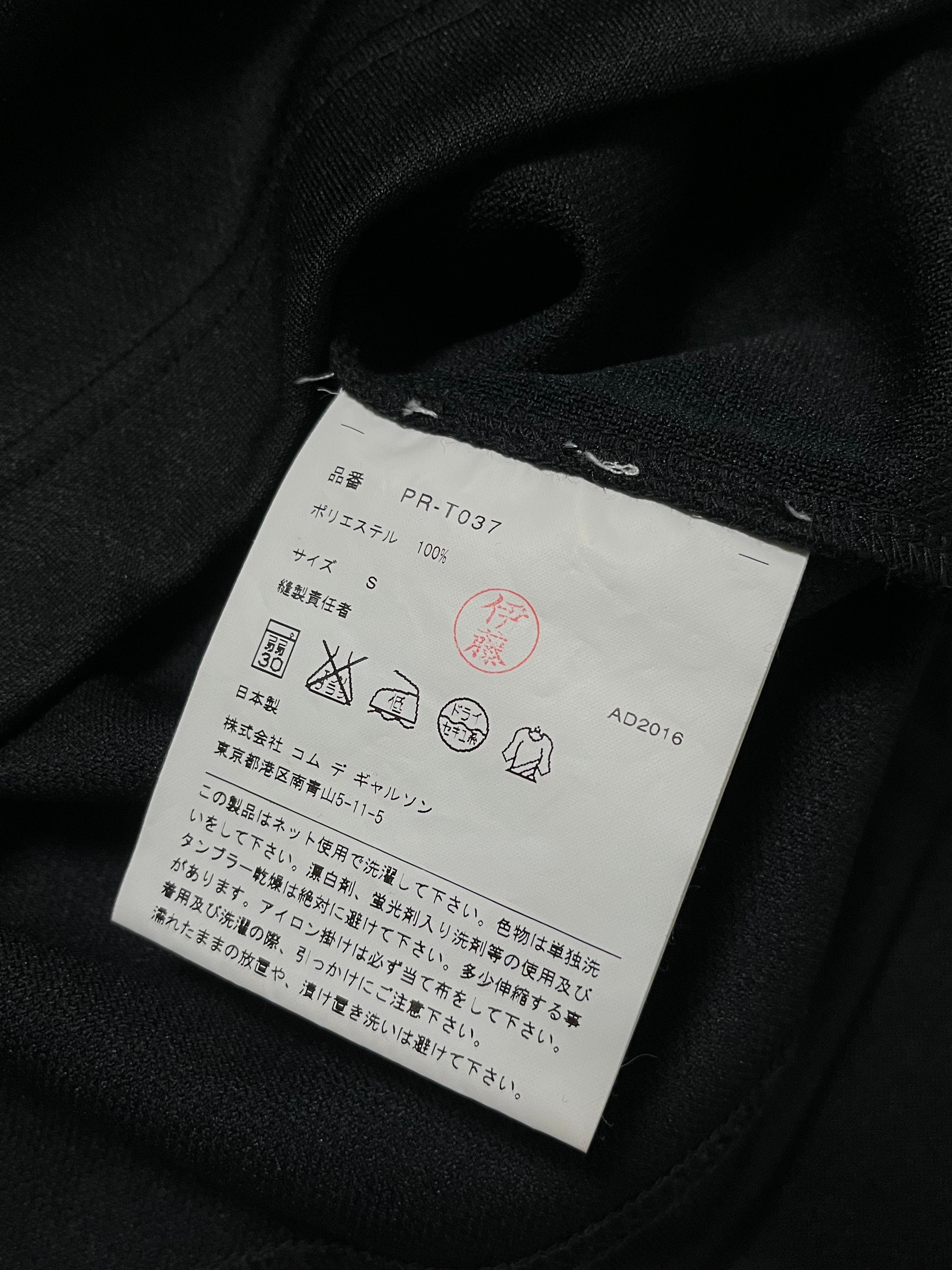 Comme des Garçons Homme Plus Armour Of Peace studded longsleeve shirt with metal embellishments and black fabric.