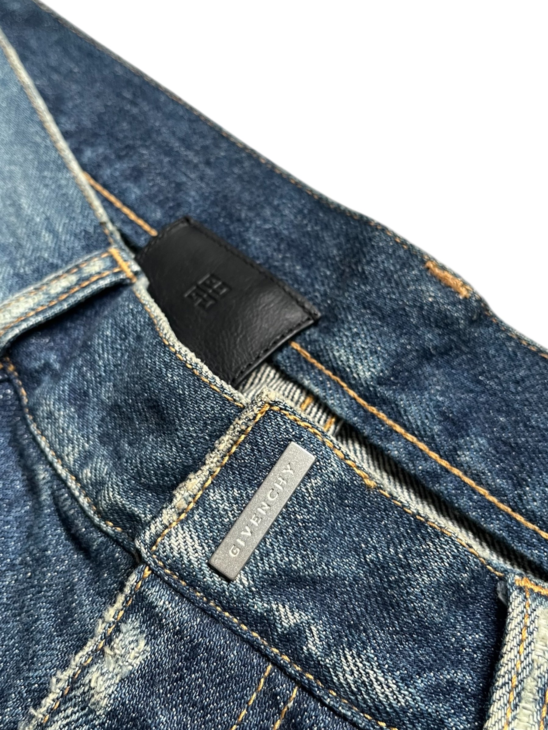 Givenchy FW23 distressed boro blue denim pants, casual fit with ripped details, showcasing the trendy denim design.