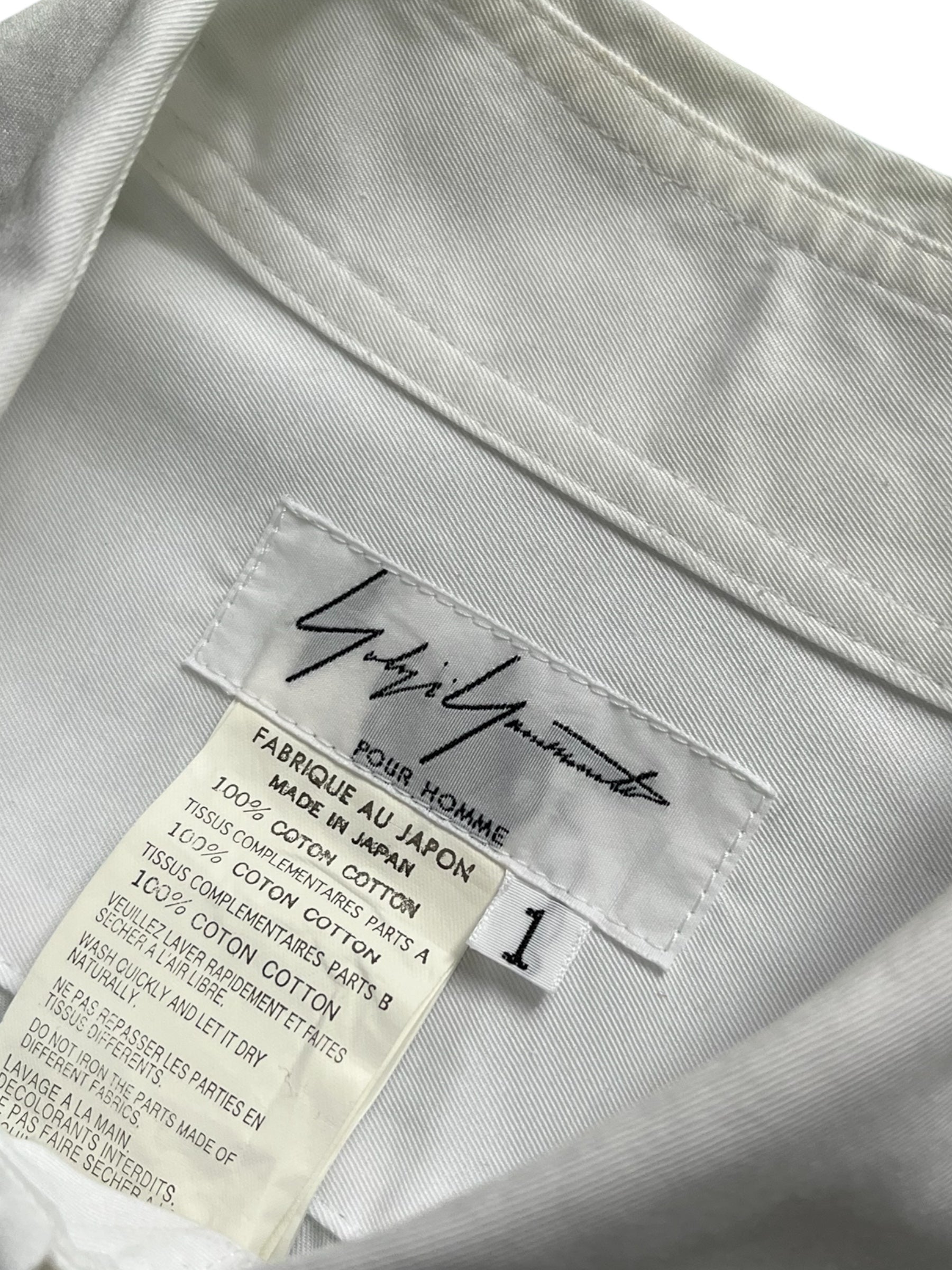 Yohji Yamamoto SS07 Trompe-L’œil suspenders shirt with printed design, long sleeves, and classic collar, displayed on a mannequin.