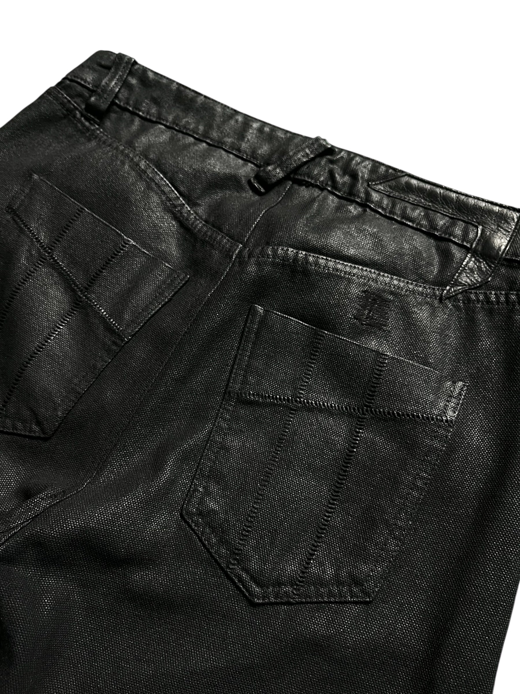 Boris Bidjan Saberi P-13 J-Cut waxed denim pants with unique cut details and distressed finish, displayed on a plain background.