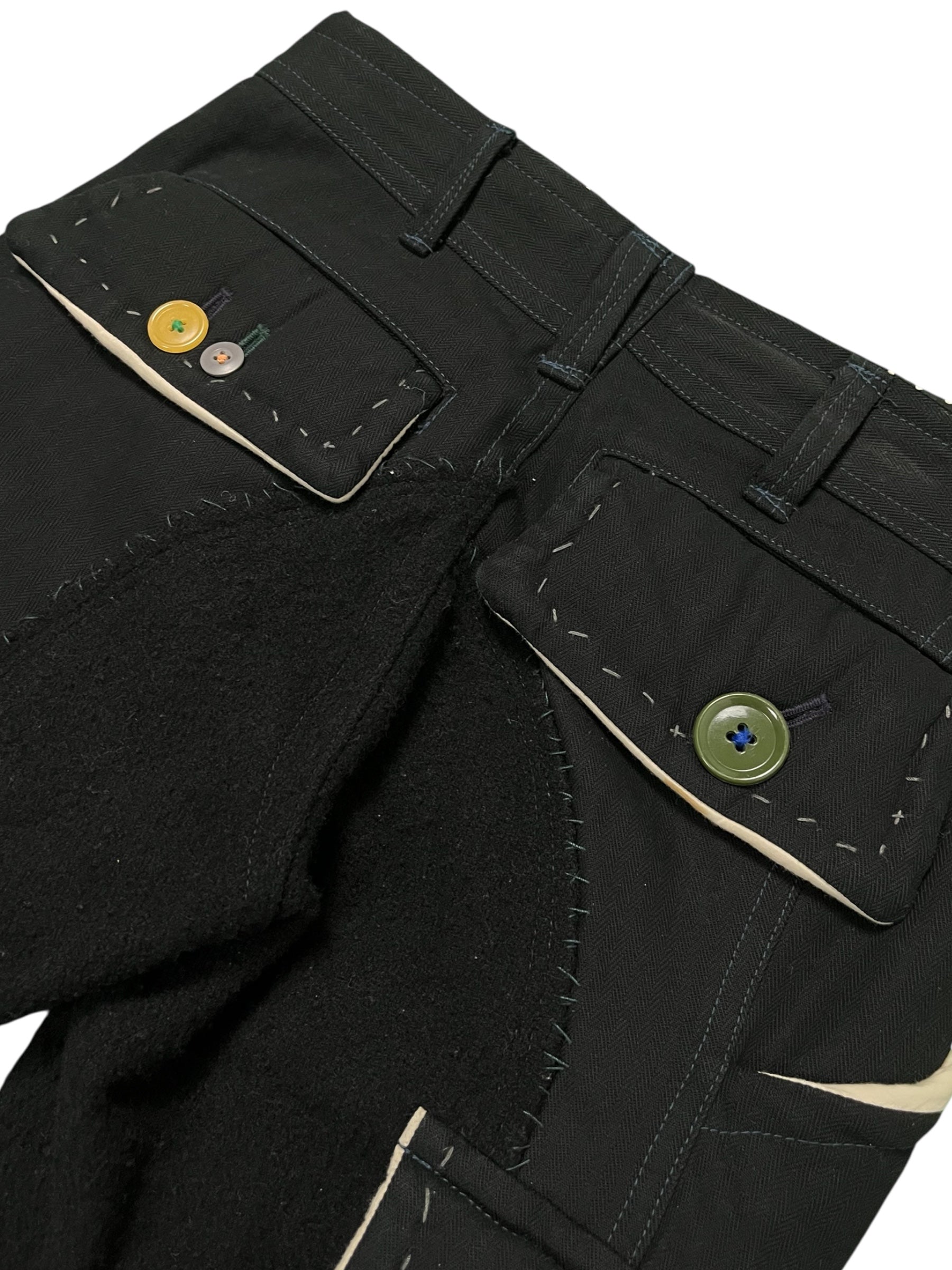 Undercover AW04 "But Beautiful" cargo pants featuring a parasitic and stuffed design, with a relaxed fit and detailed fabric texture.