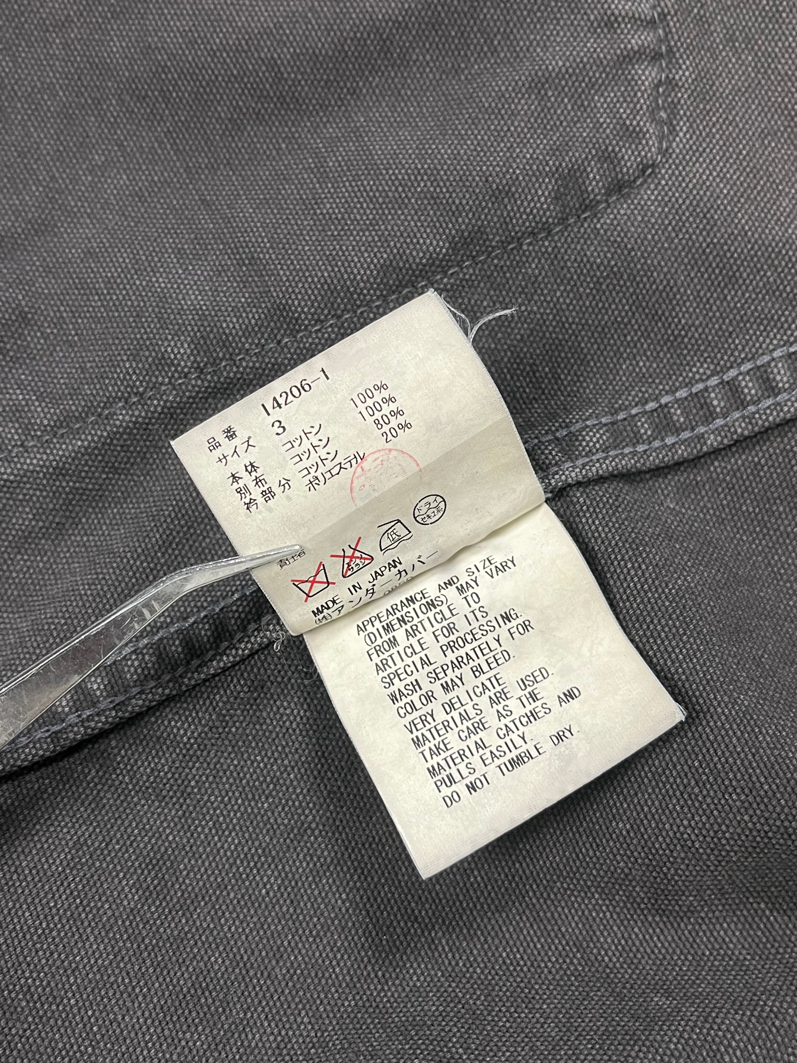Undercover SS12 Openstrings work jacket showing its rugged fabric, open front design, and casual fit on a plain background.