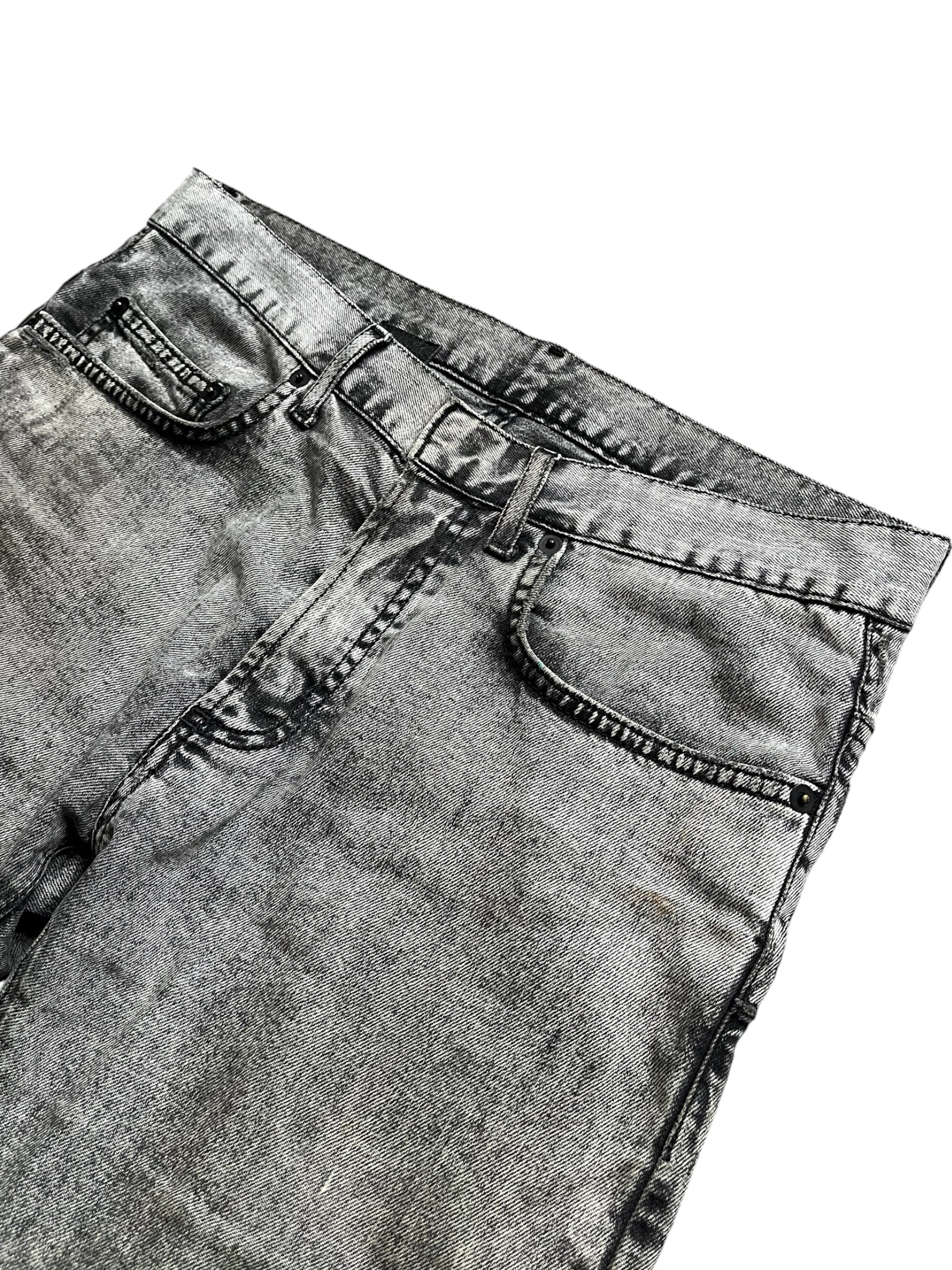 Dior SS15 acid wash slim fit denim pants with distressed details and classic five-pocket design, shown on a model.