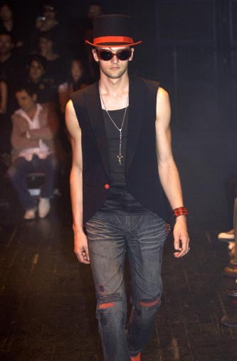 Number (N)ine SS05 Nightcrawler distressed denim pants with ripped details and a relaxed fit, shown in a close-up view.