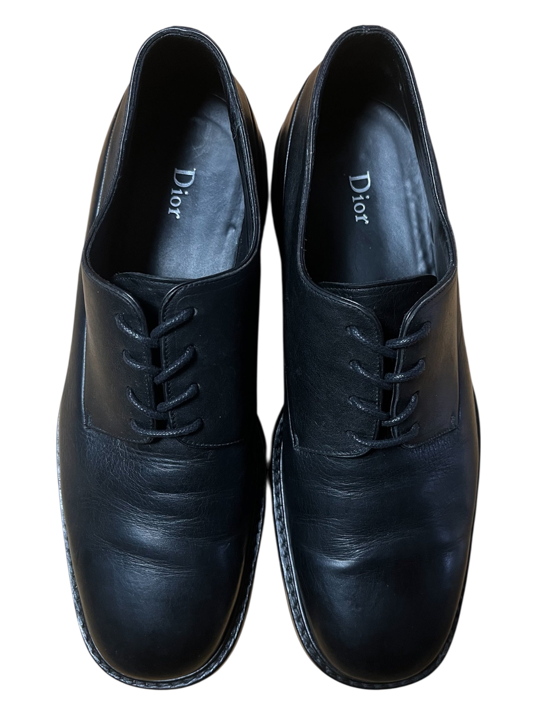 Dior black leather derbies shoes with sleek design and polished finish, featuring lace-up closure and classic footwear style.