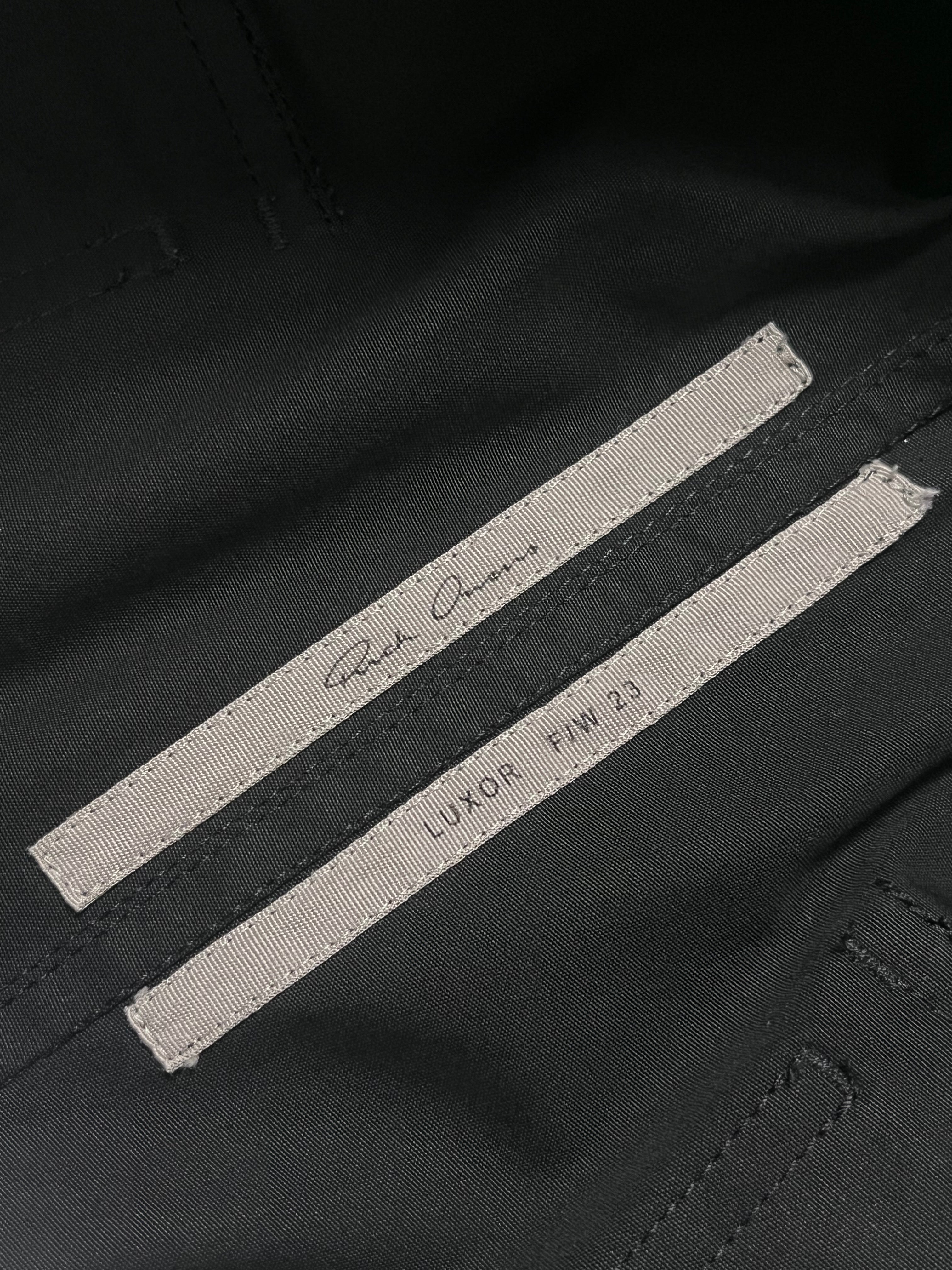 Rick Owens FW23 Luxor Bauhaus Cargo Jogger Pants in black with multiple pockets and relaxed fit, displayed flat on a white background.