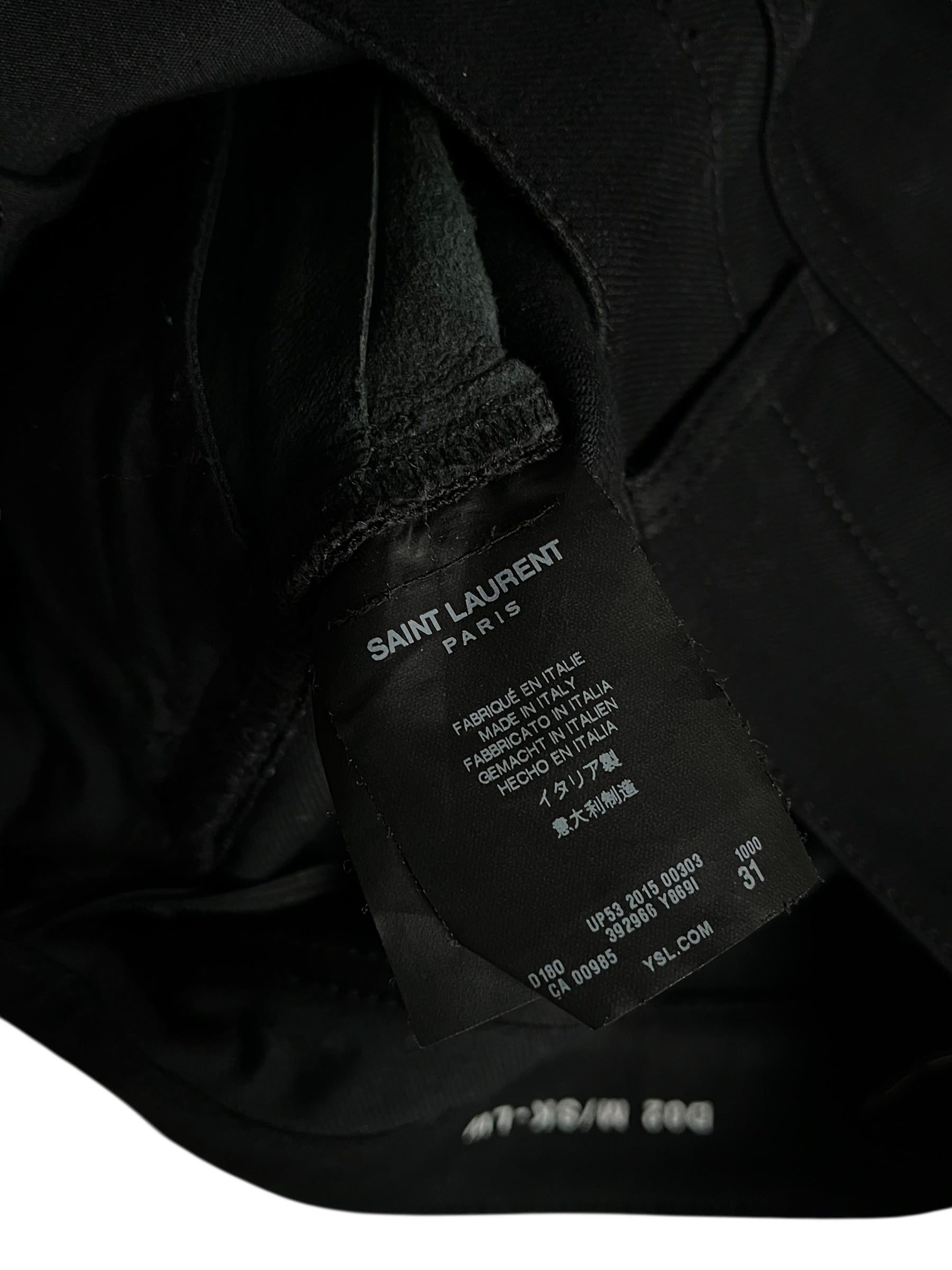 Saint Laurent AW15 Five Zips Biker Denim Pants with multiple zip details and slim fit, displayed on a hanger.