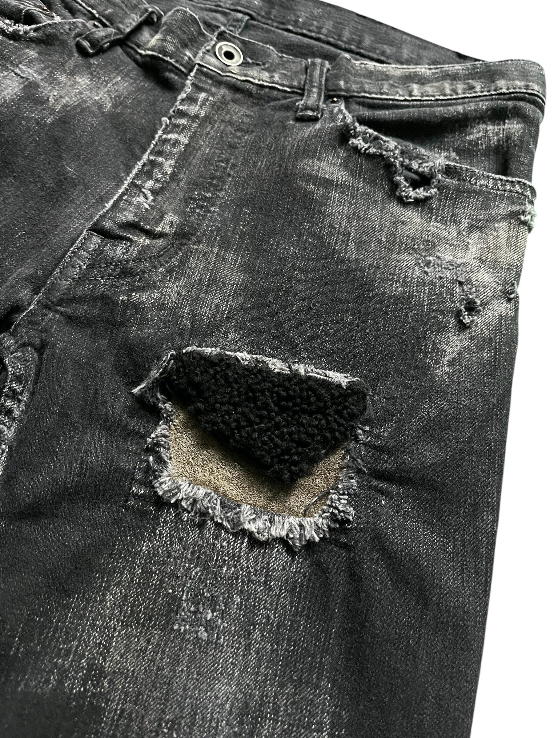 Le Grande Bleu Wolf Cut Waxed Distressed Denim pants with a rugged, vintage style and faded, worn-in look.
