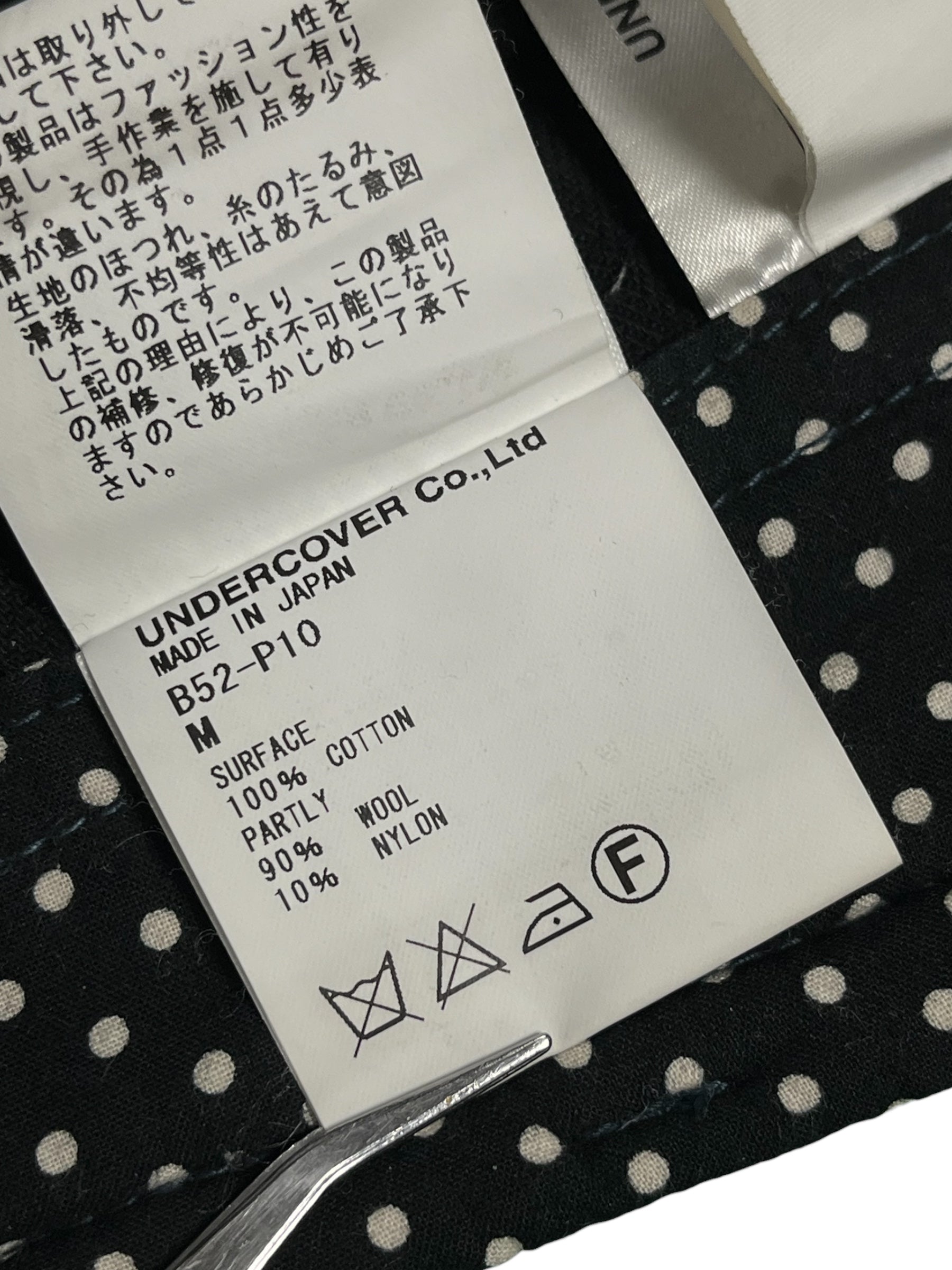 Undercover AW04 "But Beautiful" cargo pants featuring a parasitic and stuffed design with multiple pockets and a relaxed fit.
