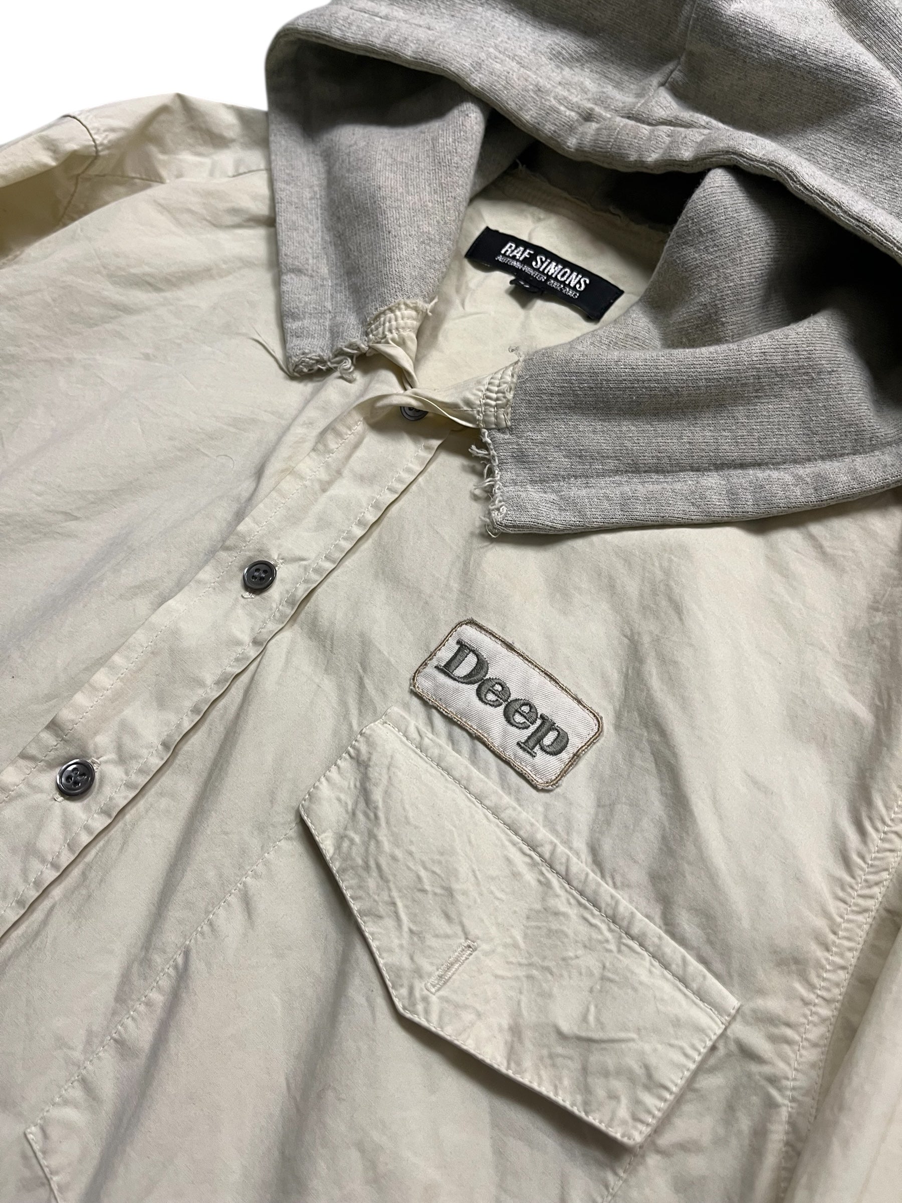 Raf Simons Virginia Creeper deep hooded shirt in dark fabric with hood and casual fit, front and side views.