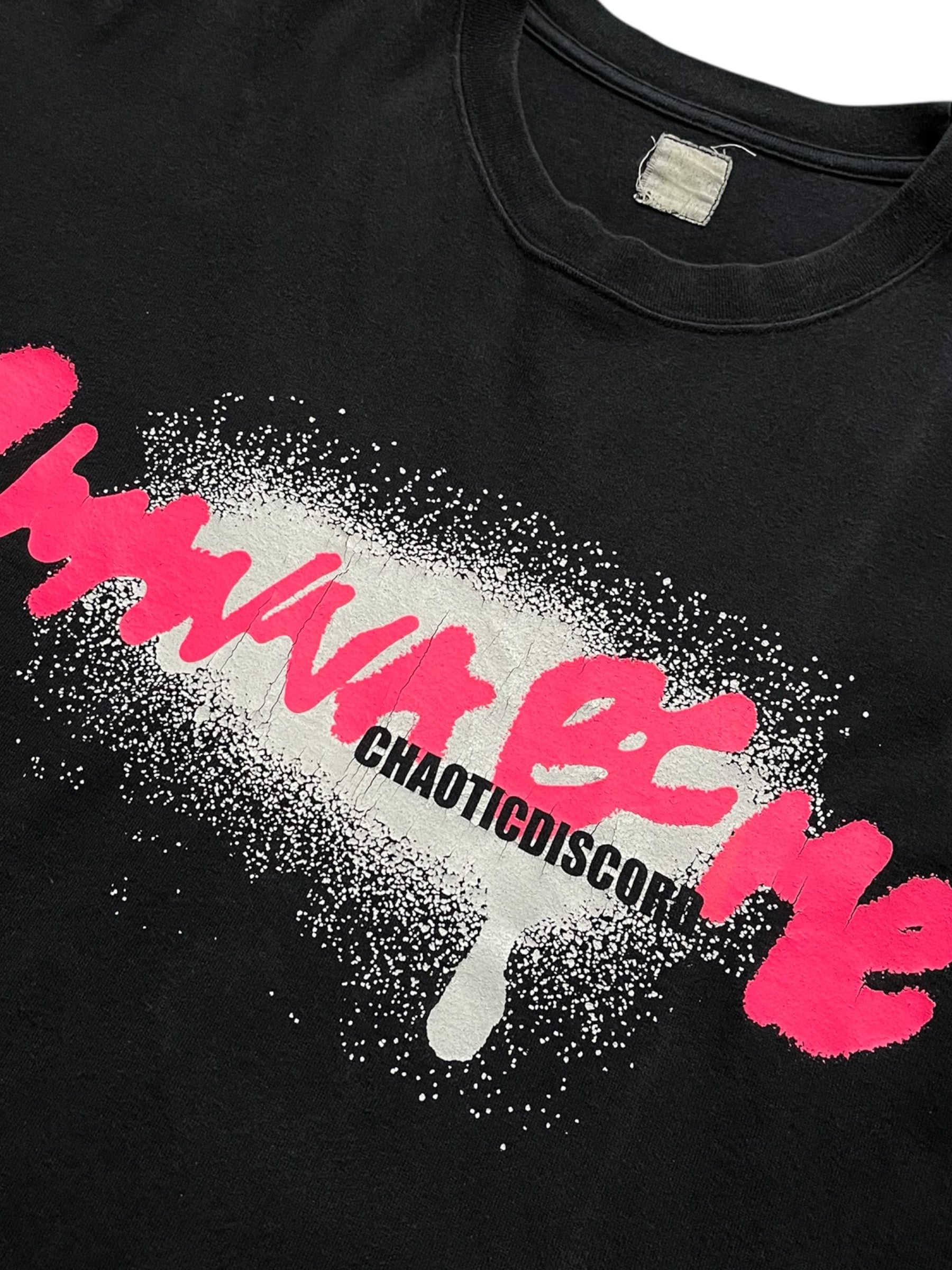 Undercover SS01 "Chaotic Discord" graffiti T-shirt featuring bold, colorful street art design on a casual black T-shirt.