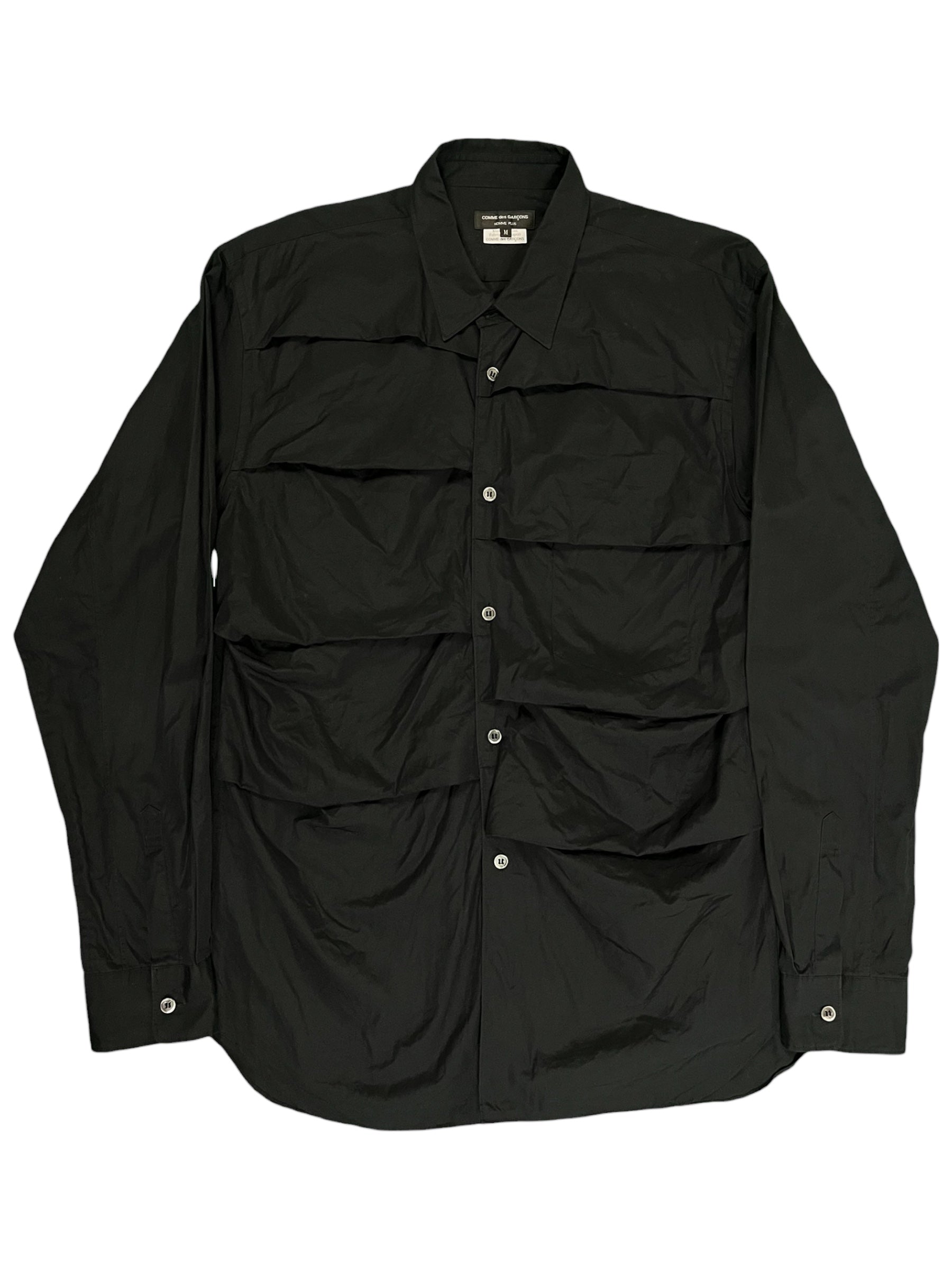 Comme des Garçons Homme Plus SS19 paneled shirt with contrasting fabric sections and classic collar, displayed on a neutral background.
