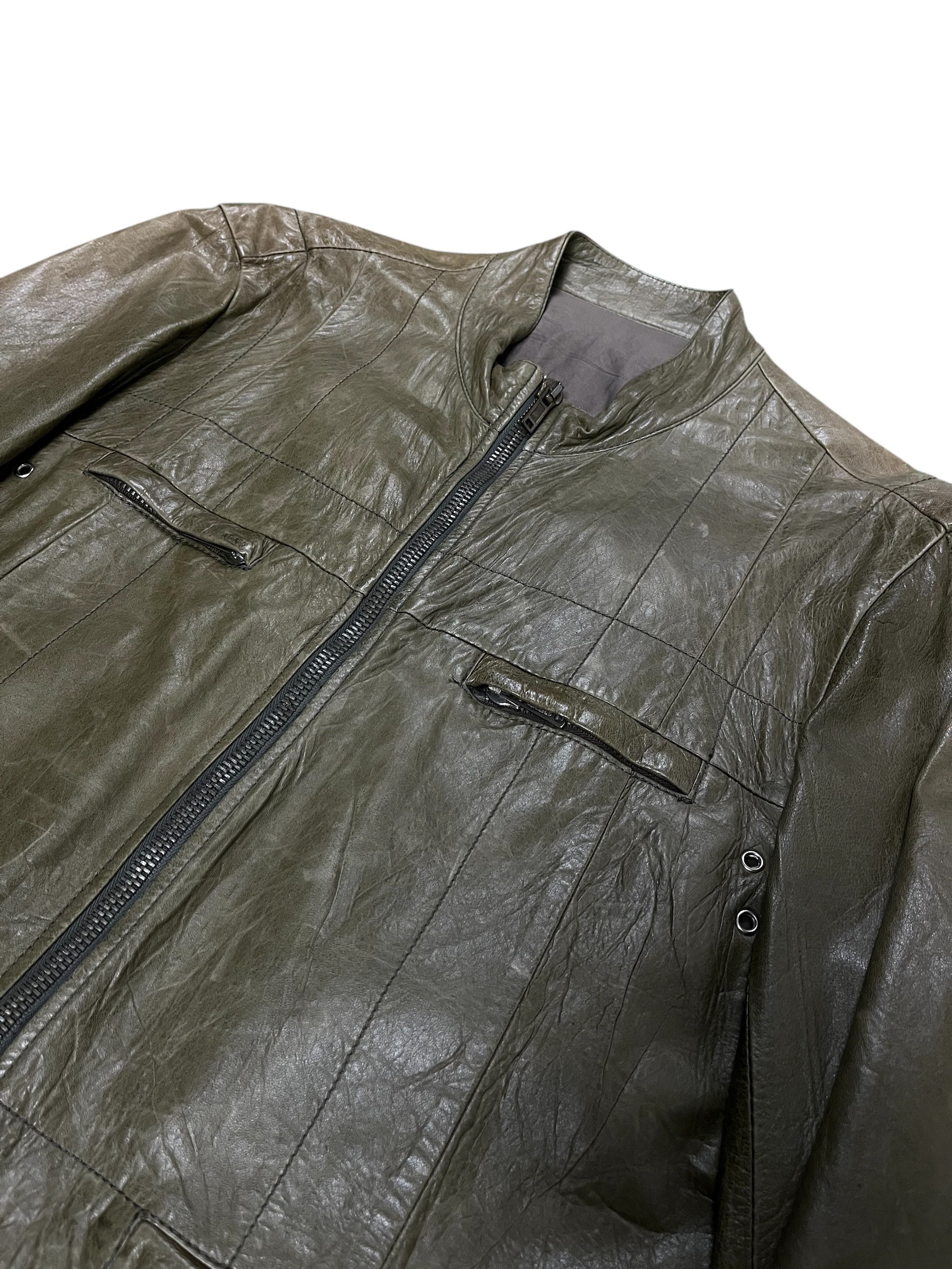 Rick Owens AW04 "Queen" runway green lambskin jacket with sleek design, displayed on a hanger against a neutral background.