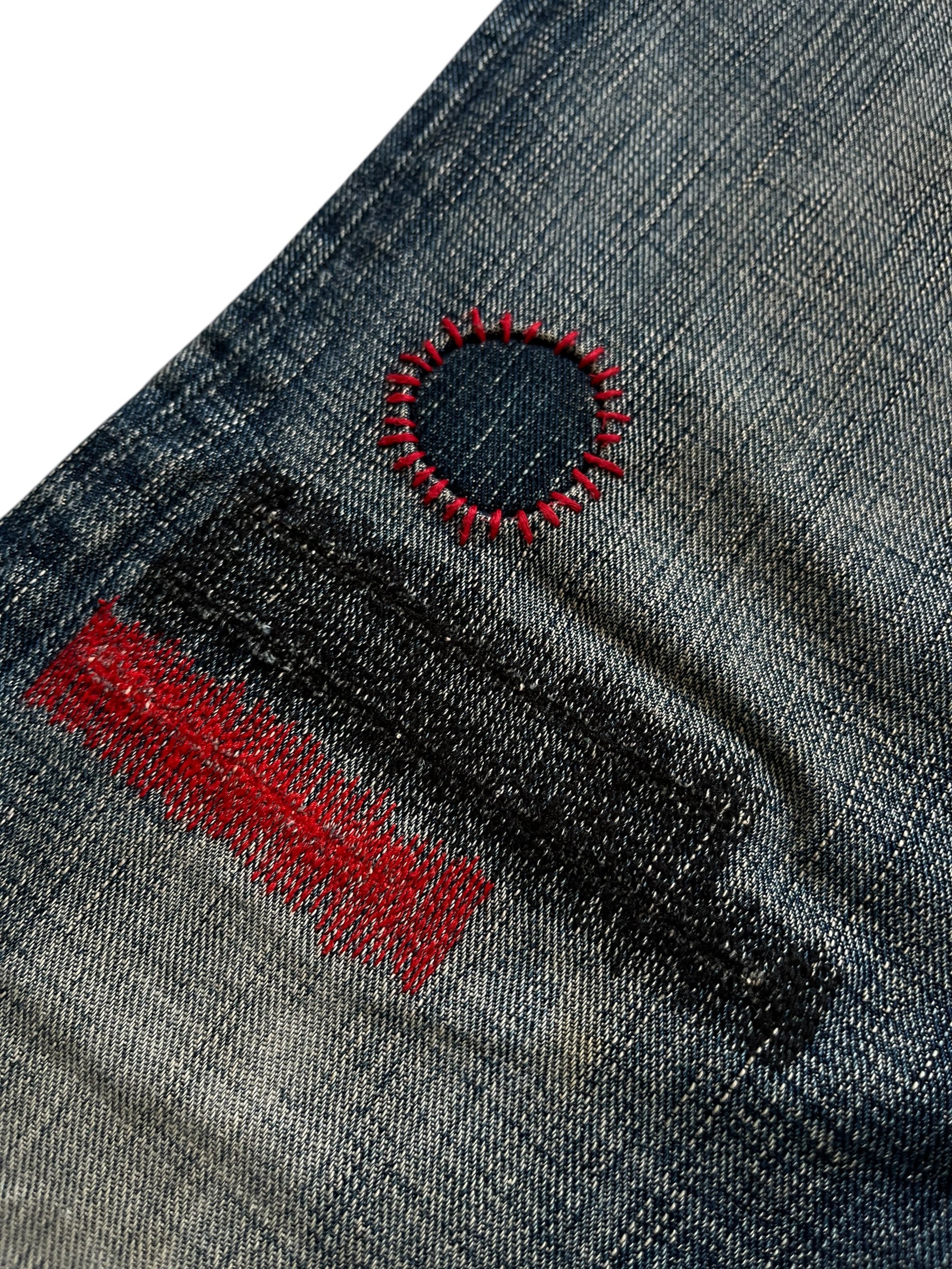 Number (N)ine SS05 Nightcrawler distressed denim pants with ripped details and a slim fit, displayed on a hanger.
