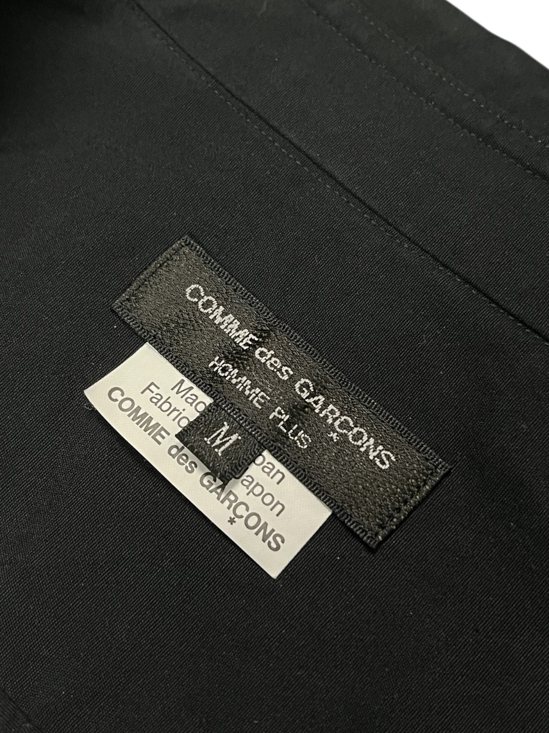 Comme des Garçons Homme Plus SS19 paneled shirt with contrasting fabric panels and a classic collar, displayed on a white background.