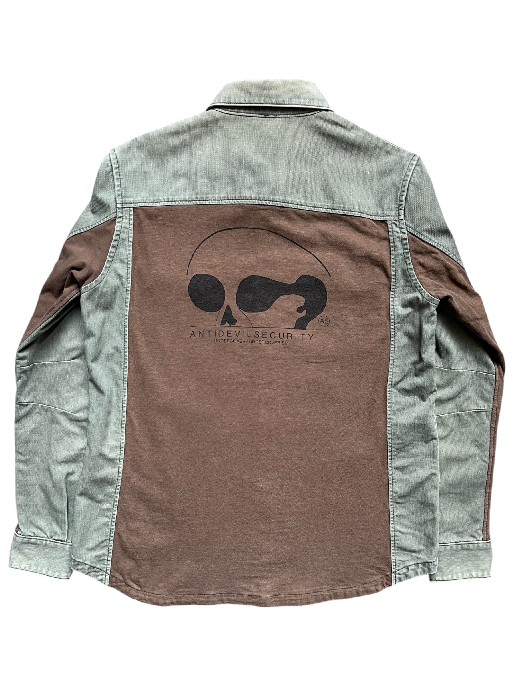 Undercover SS11 "Underman" Anti-Devil military shirt in dark fabric with tactical design and button details.