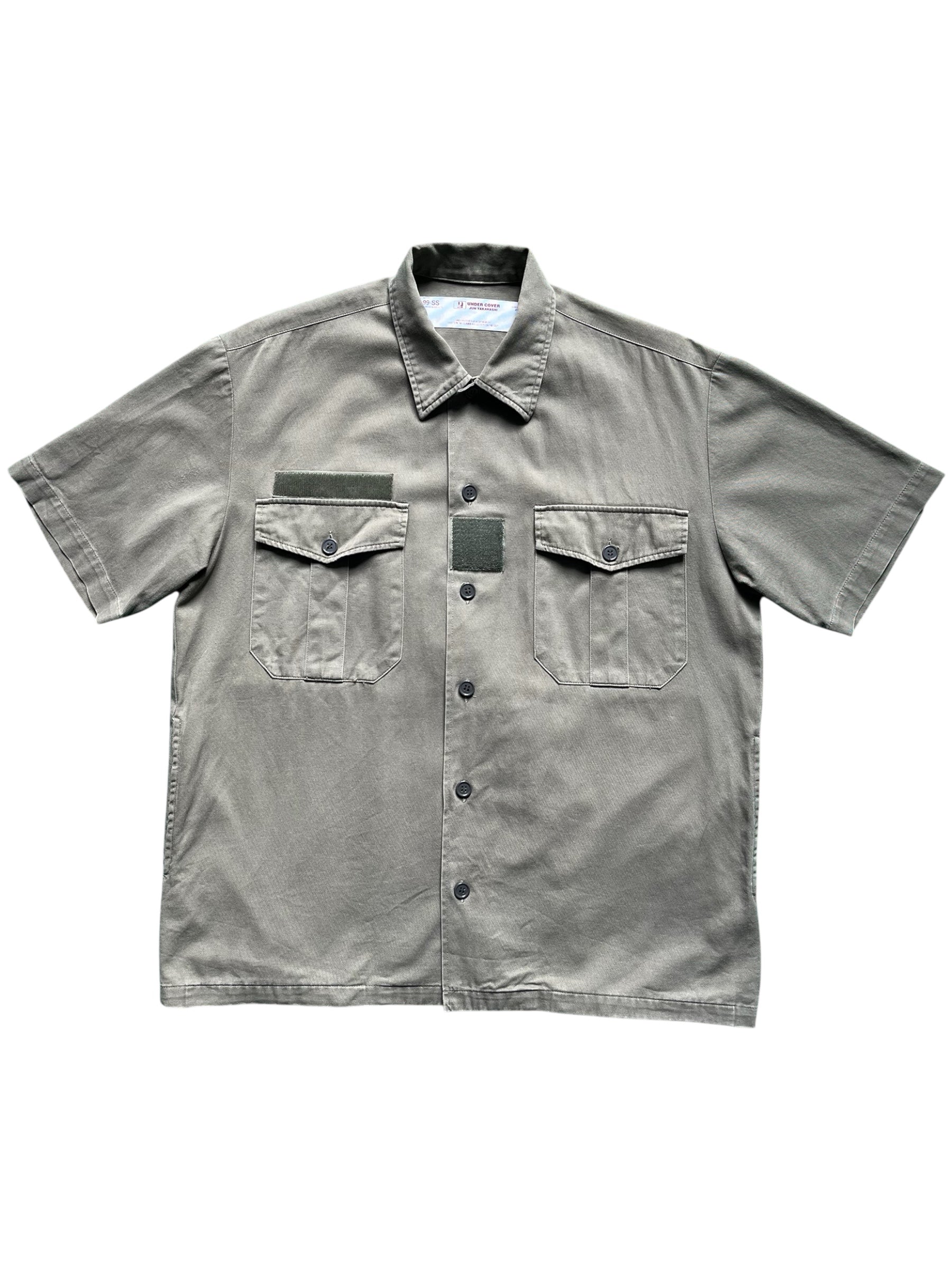 Undercover SS99 "Relief" Groupie Military Shirt displayed flat with camouflage and military-inspired design details.