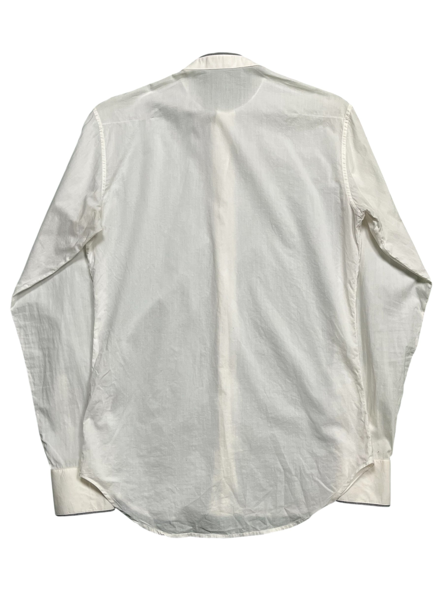 Dior SS07 “We Look Good Together” collarless shirt in light fabric, displayed on a hanger with a clean background.
