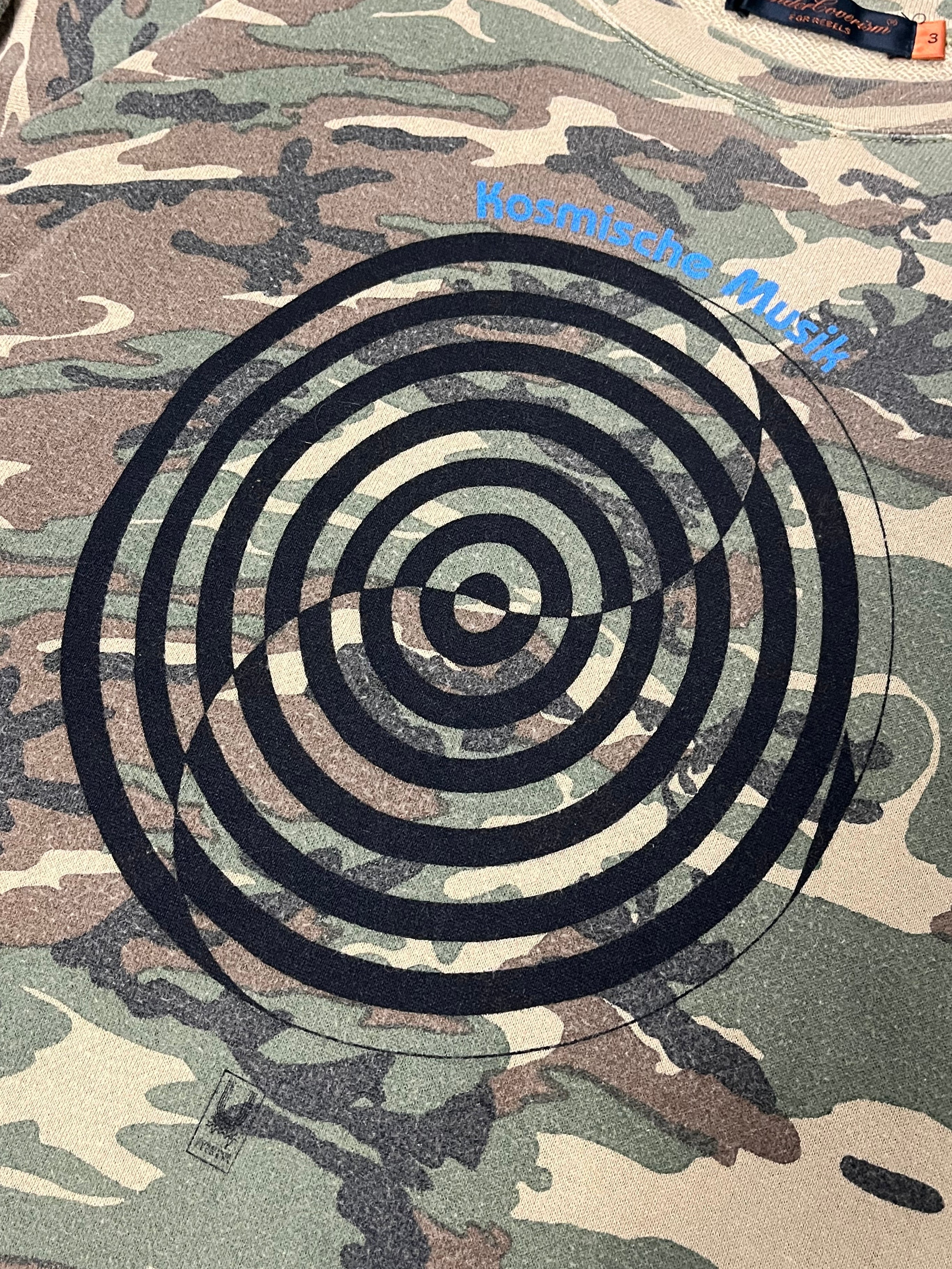 Undercover SS06 “T” Klaus Camo long sleeve T-shirt with camouflage pattern and crew neck design.