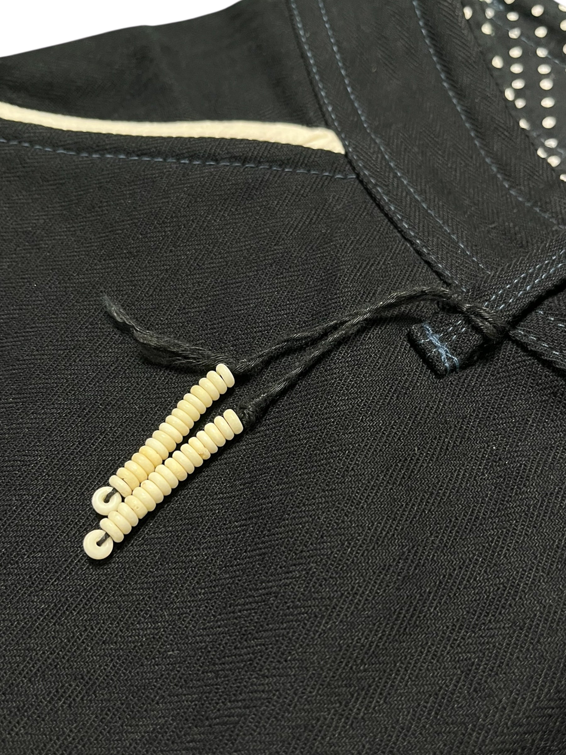 Undercover AW04 "But Beautiful" cargo pants featuring a parasitic and stuffed design with multiple pockets and unique fabric textures.