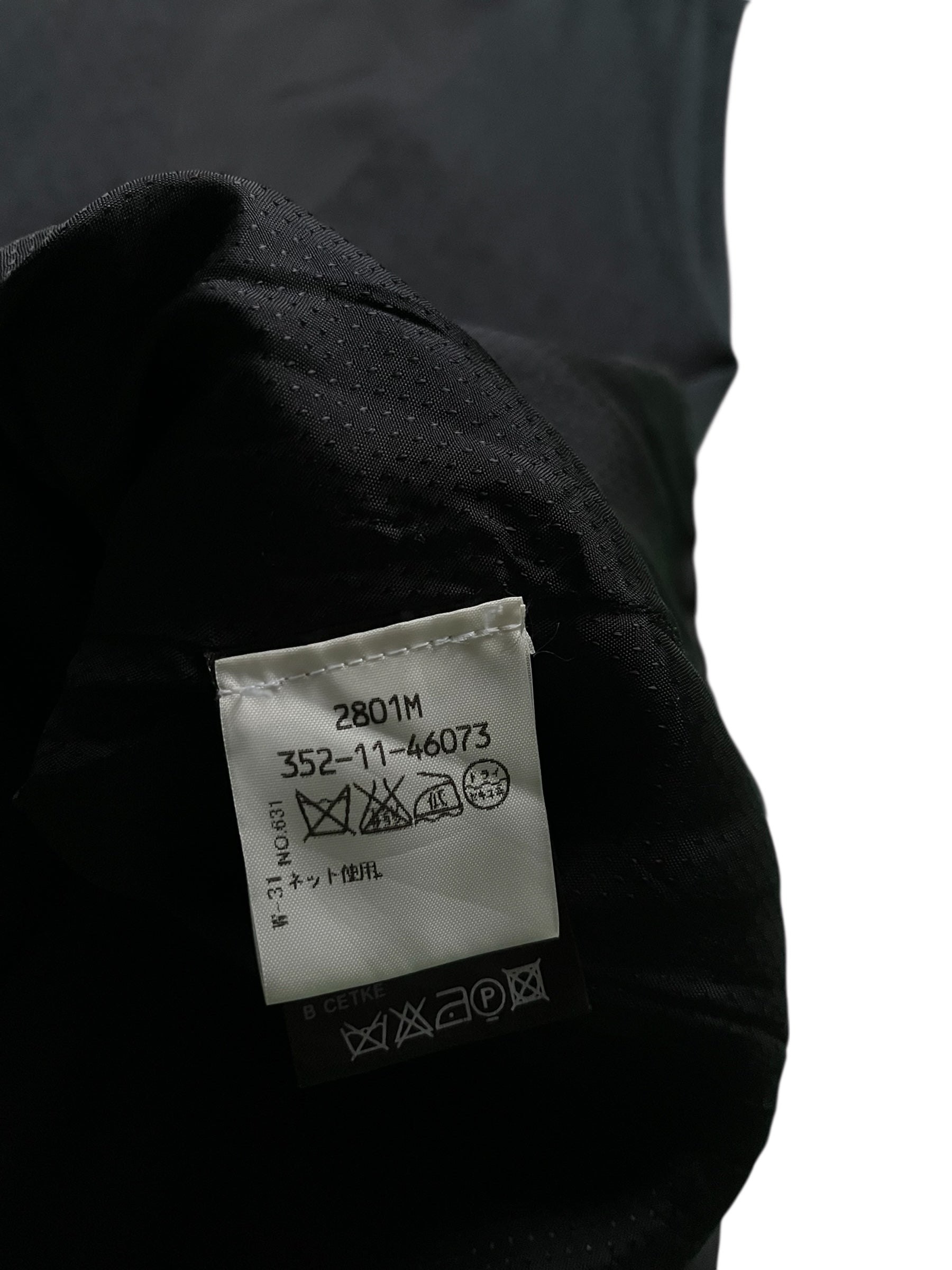 Navy wool vest by Ann Demeulemeester, close-up of the sleeveless vest with a smooth wool texture and tailored fit.