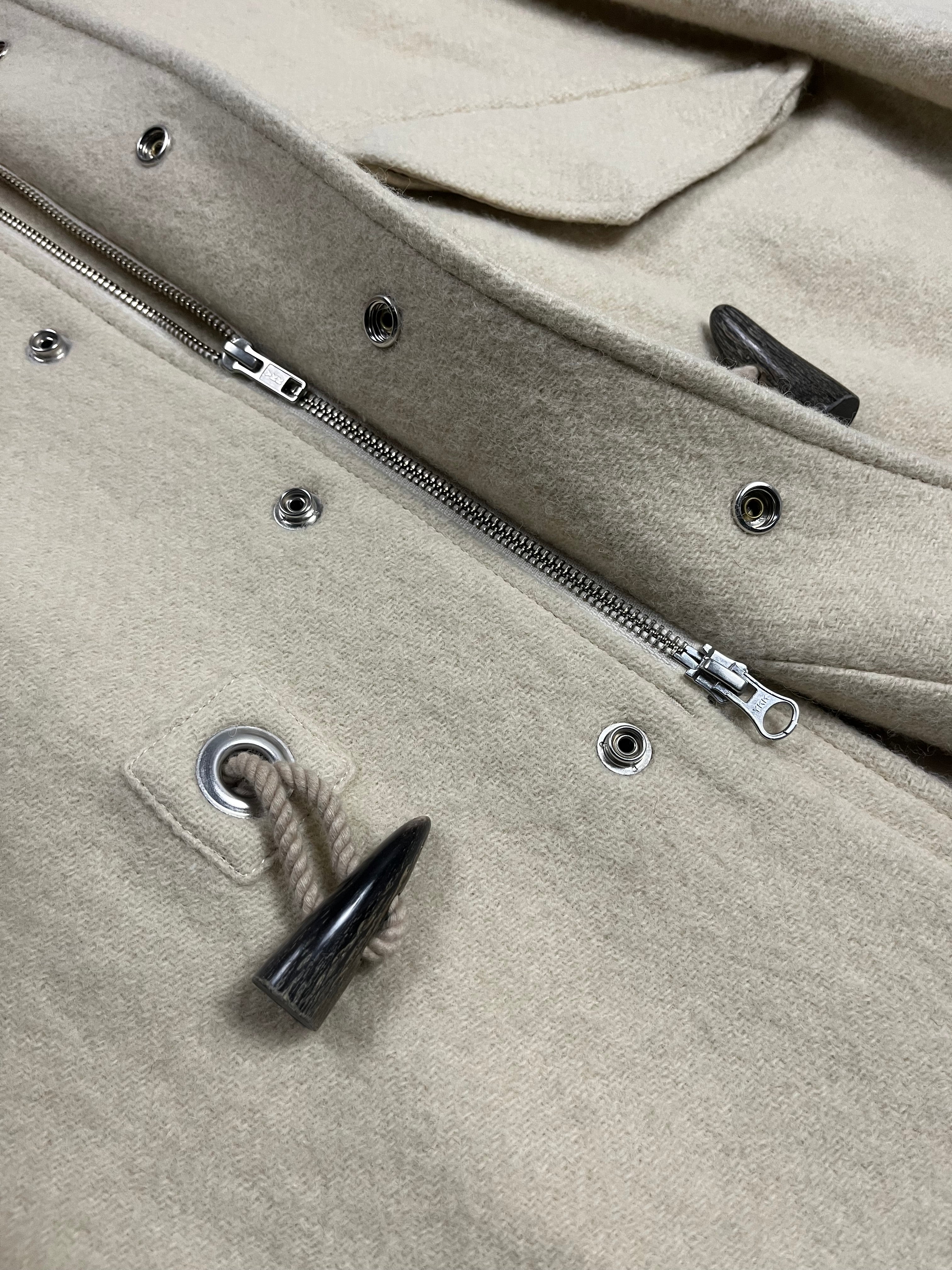Yohji Yamamoto AW07 runway hooded wool duffel coat hanging on a rack with a hood and toggle closures.