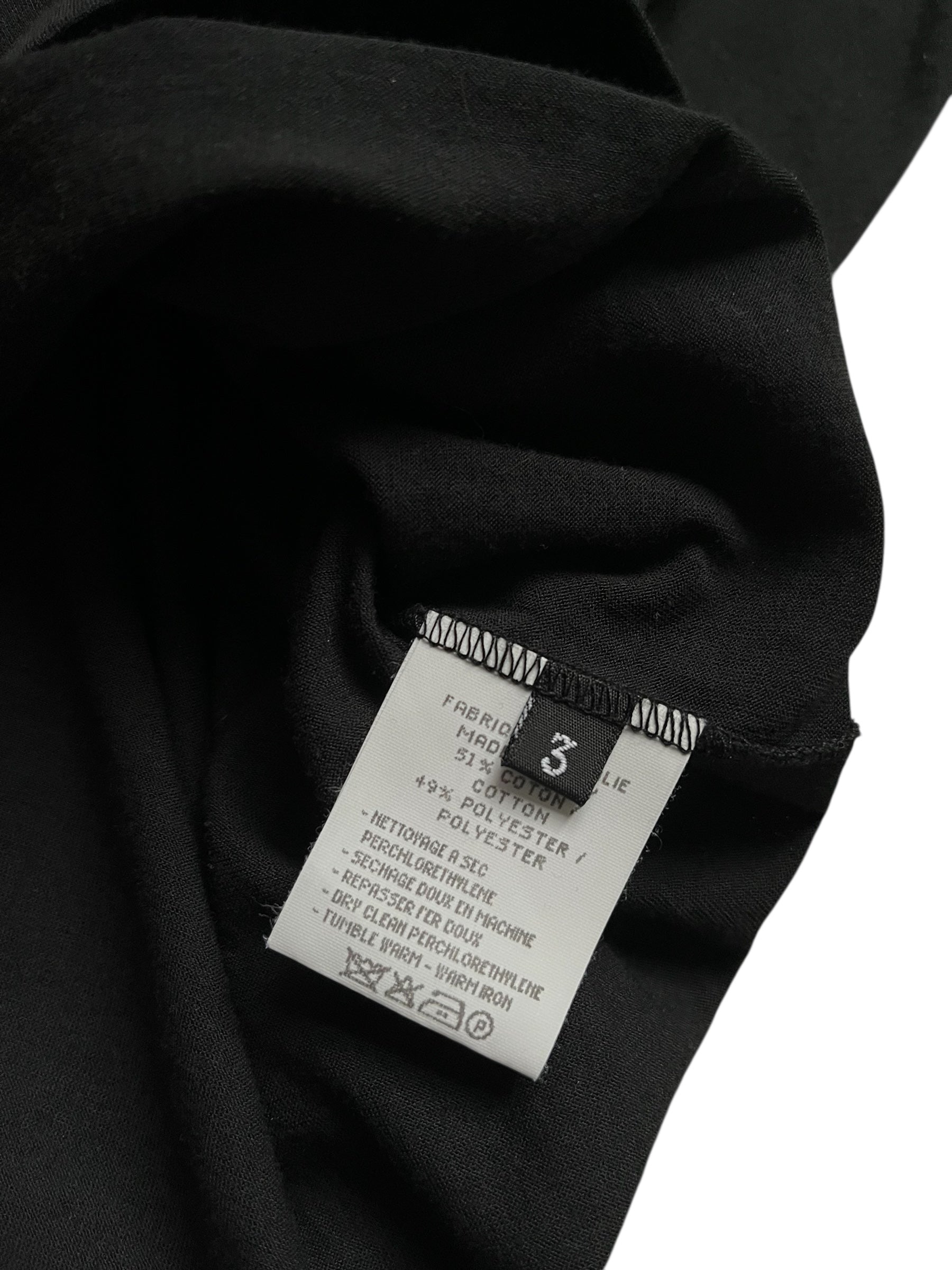 Black Yohji Yamamoto pocket T-shirt laid flat, showcasing its minimalist design and soft fabric material.