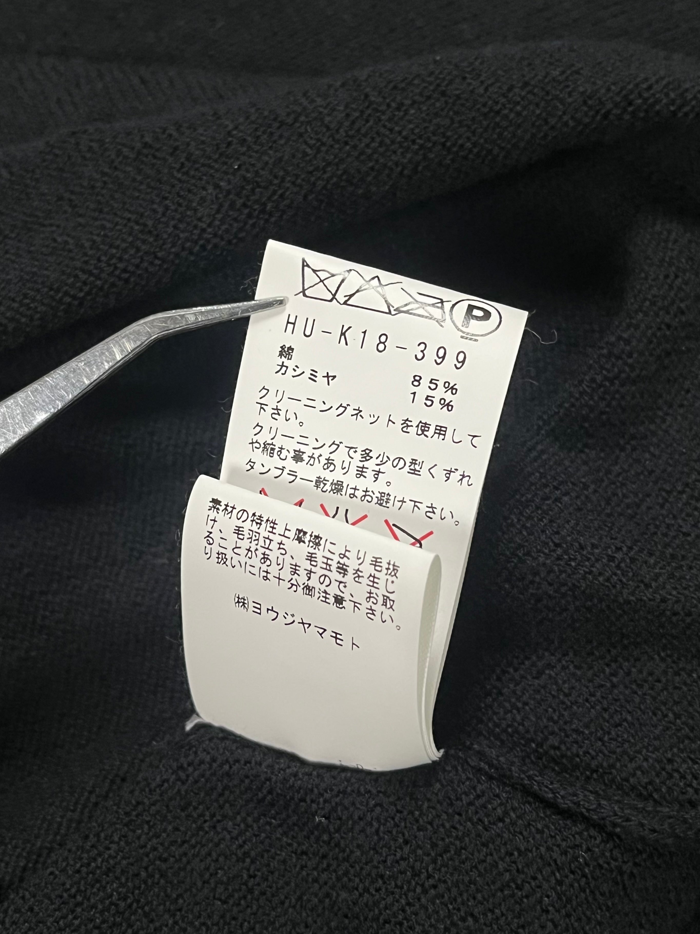 Yohji Yamamoto AW03 raglan knit long sleeve sweater in black, showing detailed knit texture and relaxed fit on a model.