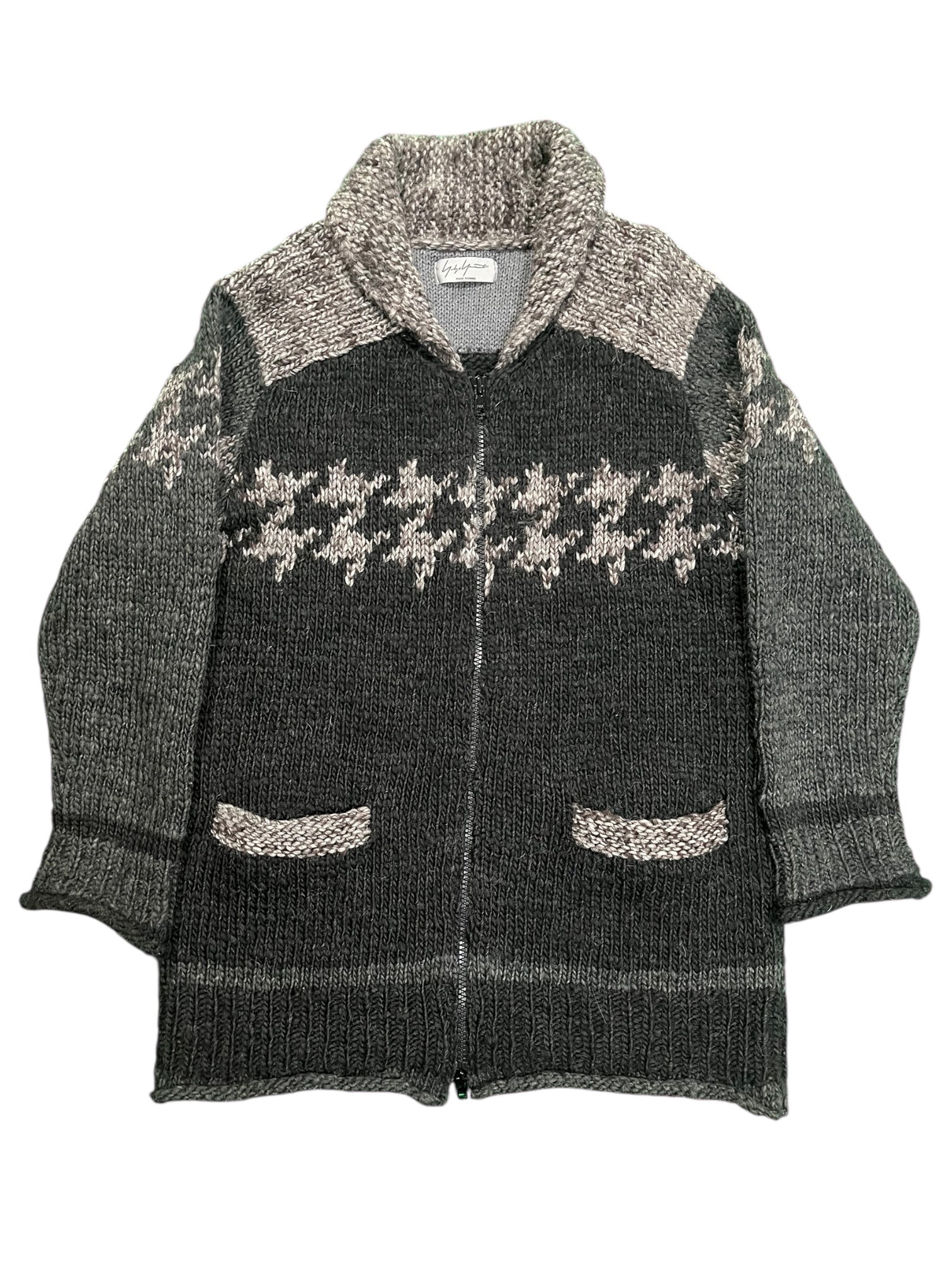 Yohji Yamamoto AW10 Cowichan Knit jacket in textured wool with a relaxed fit and earthy tones, displayed on a hanger.