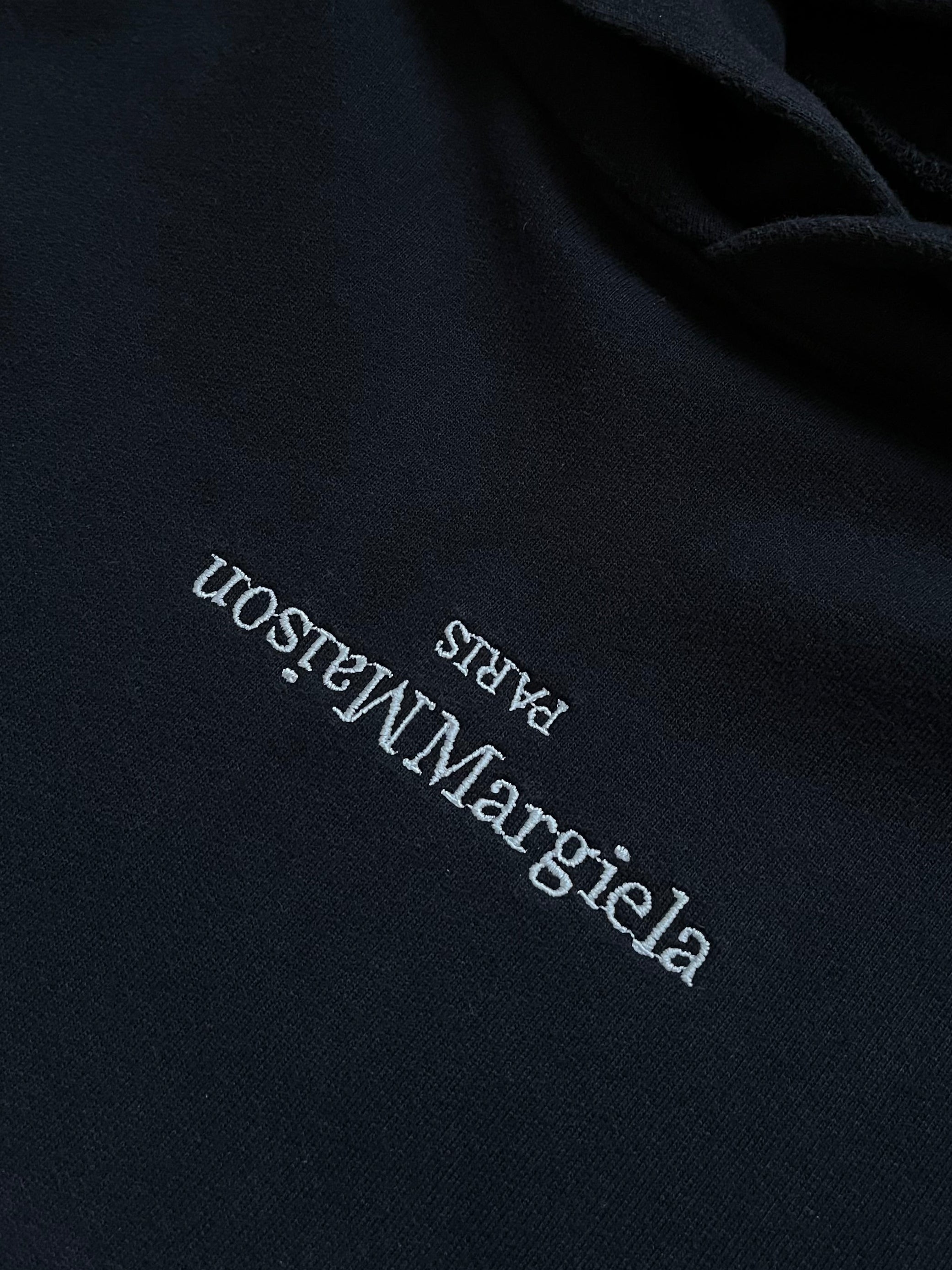 Maison Margiela SS22 distorted logo hoodie with front graphic, soft fabric, and casual fit, displayed on a neutral background.