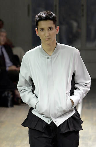 Yohji Yamamoto SS01 runway lambskin jacket with sleek design and textured leather, displayed on a runway model.