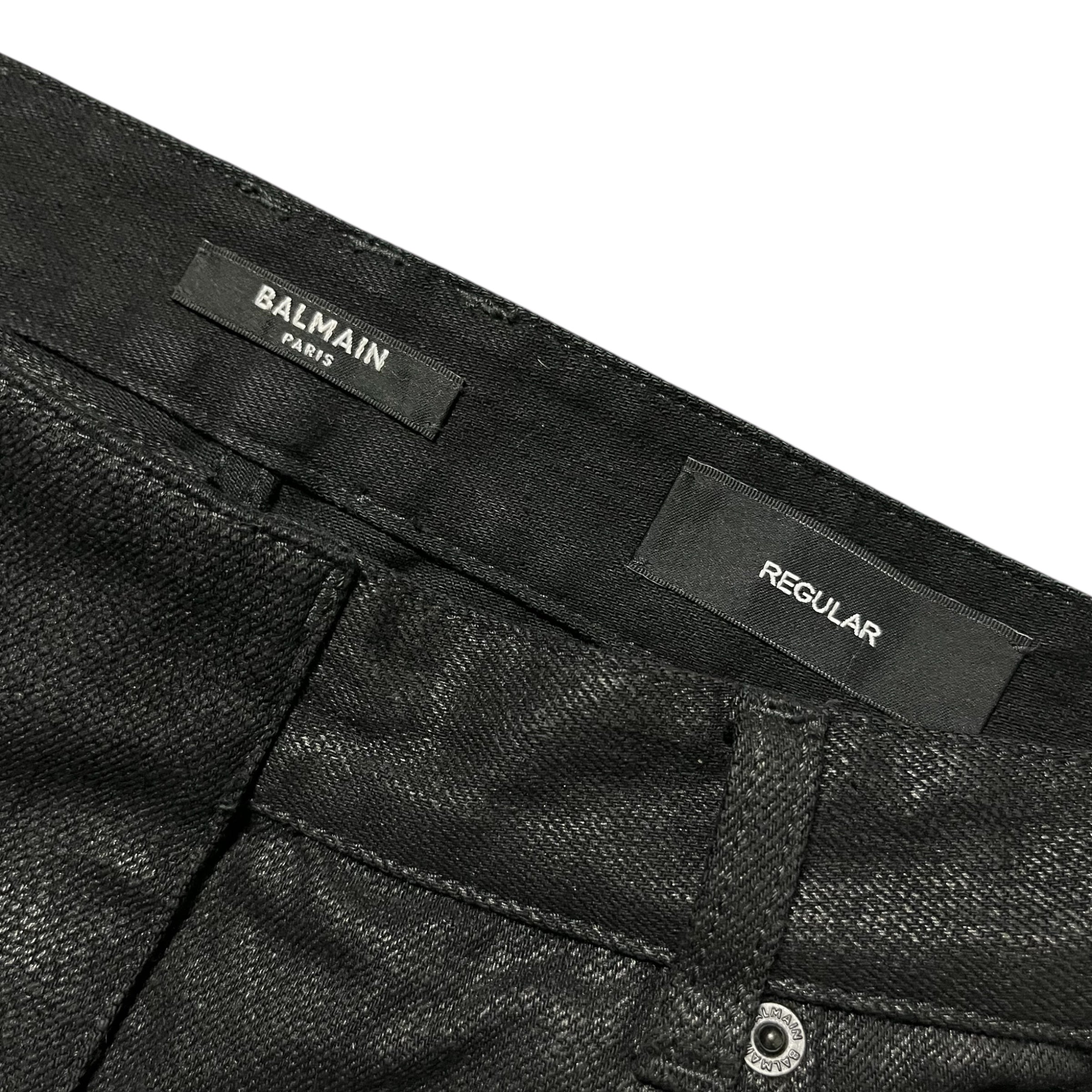 Balmain AW23 limited edition waxed denim pants with a sleek, fitted design and detailed stitching.