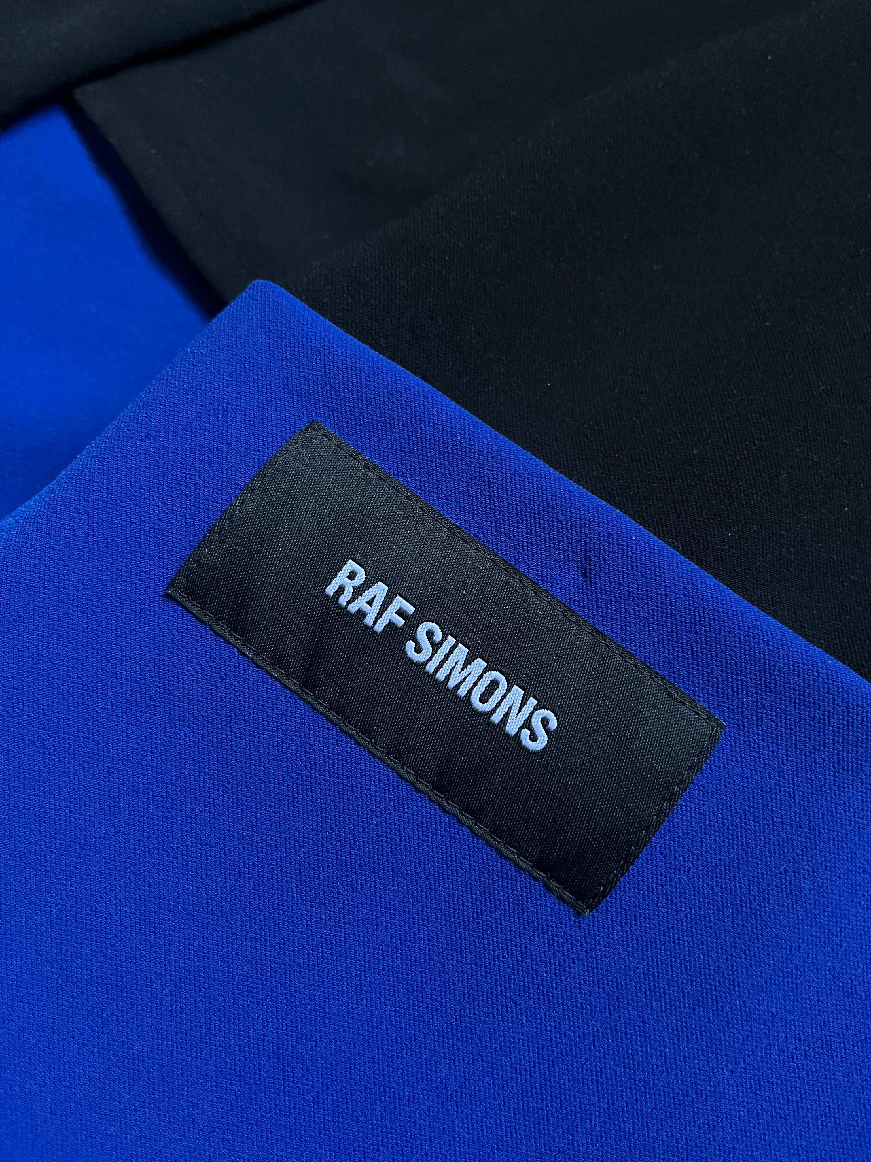 Raf Simons SS14 tri-color athletic long coat with sleek design and vibrant color blocking, styled for a modern layered look.