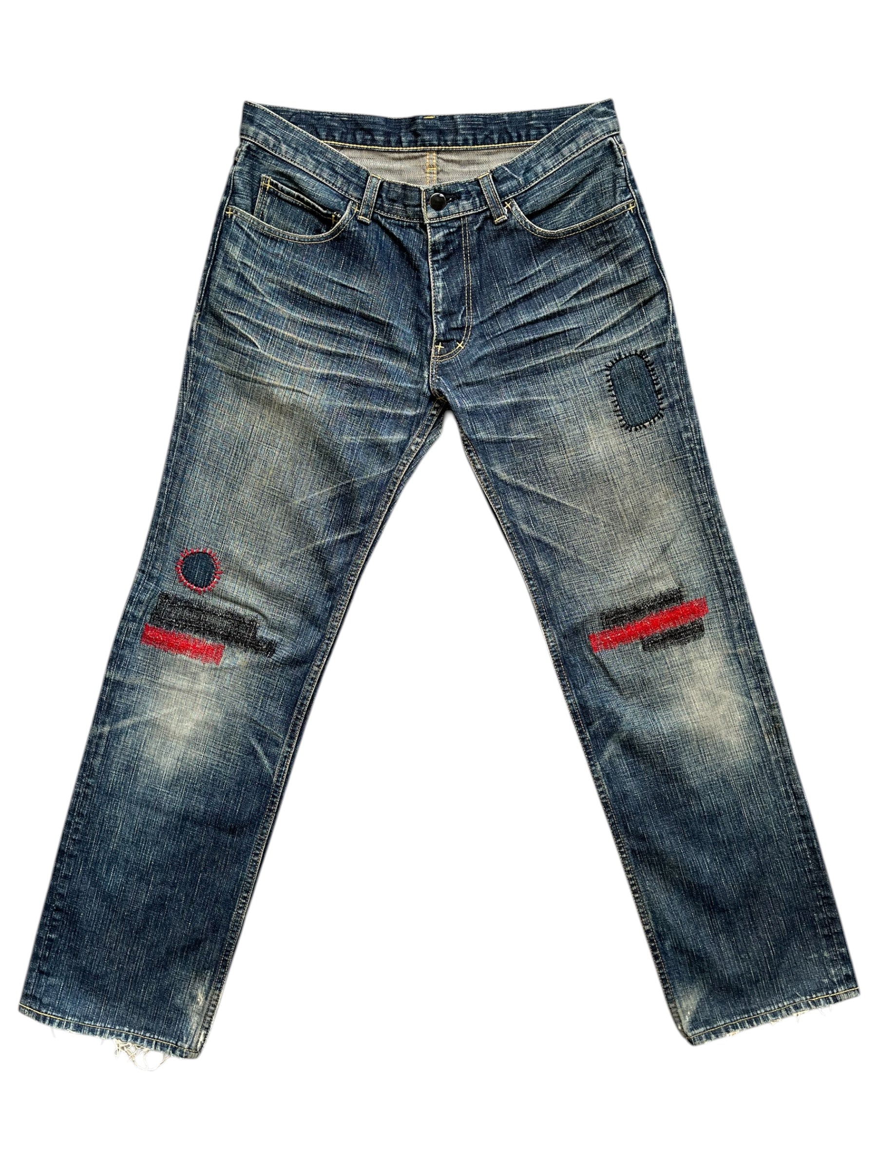 Number (N)ine SS05 Nightcrawler distressed denim pants with ripped and faded details, showcasing a relaxed fit and rugged style.
