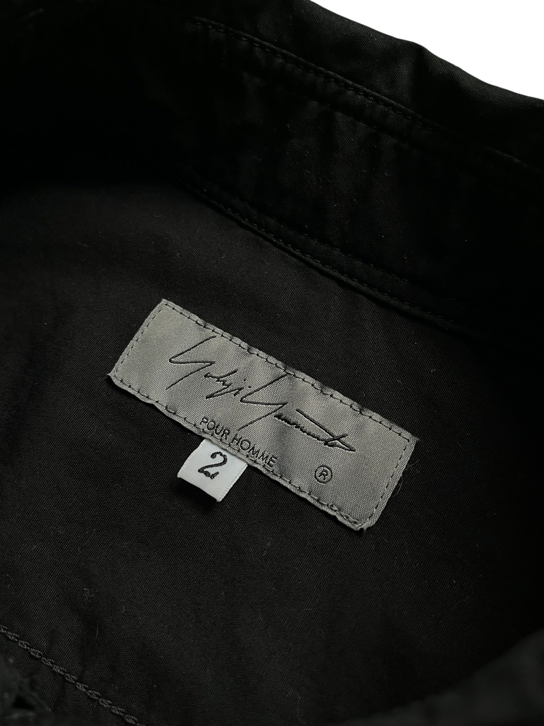 Yohji Yamamoto black oversized shirt for AW22 collection, featuring a relaxed fit and modern design, hanging on a hanger.