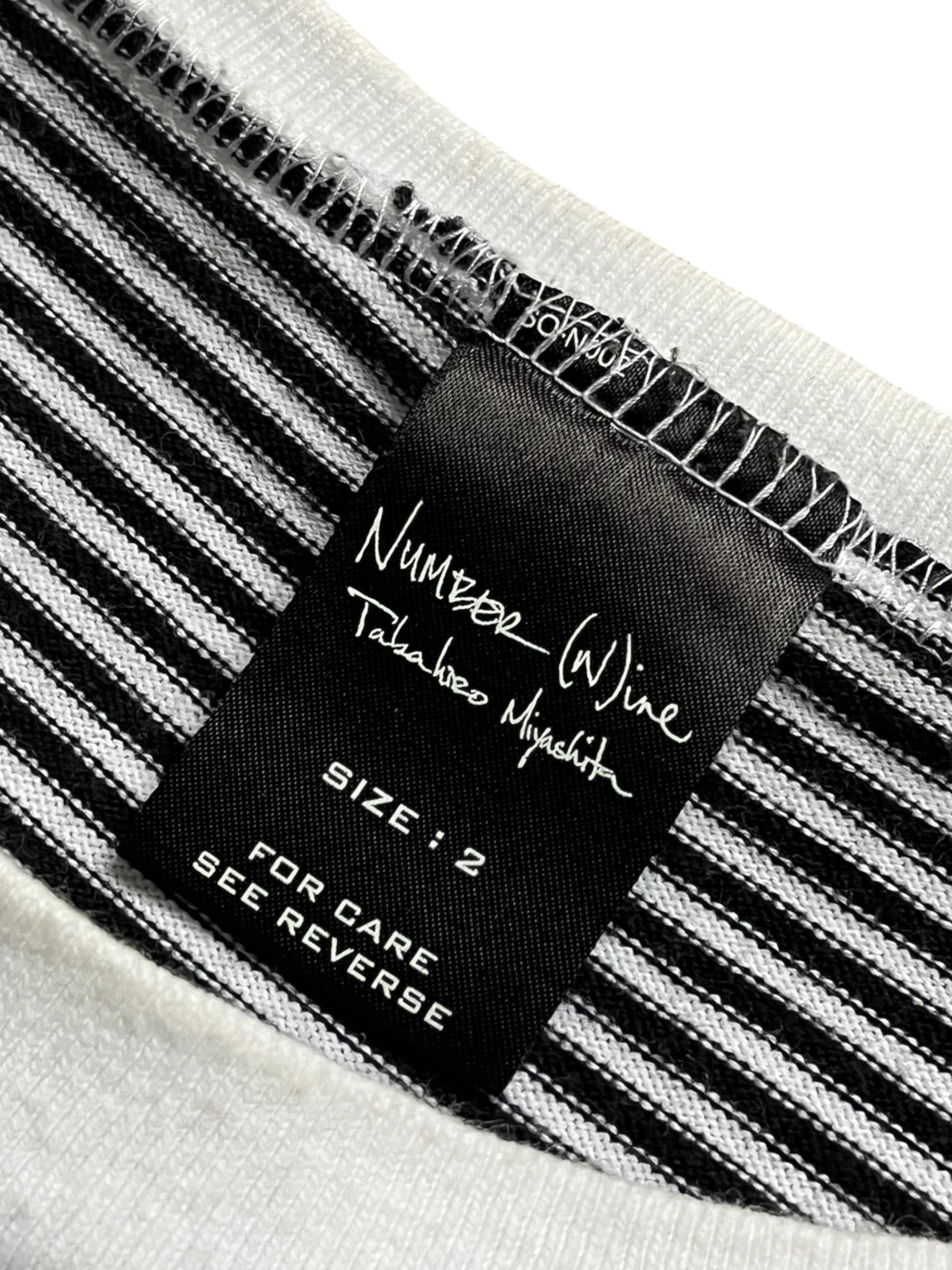 Number (N)ine AW03 "Touch Me I'm Sick" border T-shirt featuring a graphic print on a casual black T-shirt.