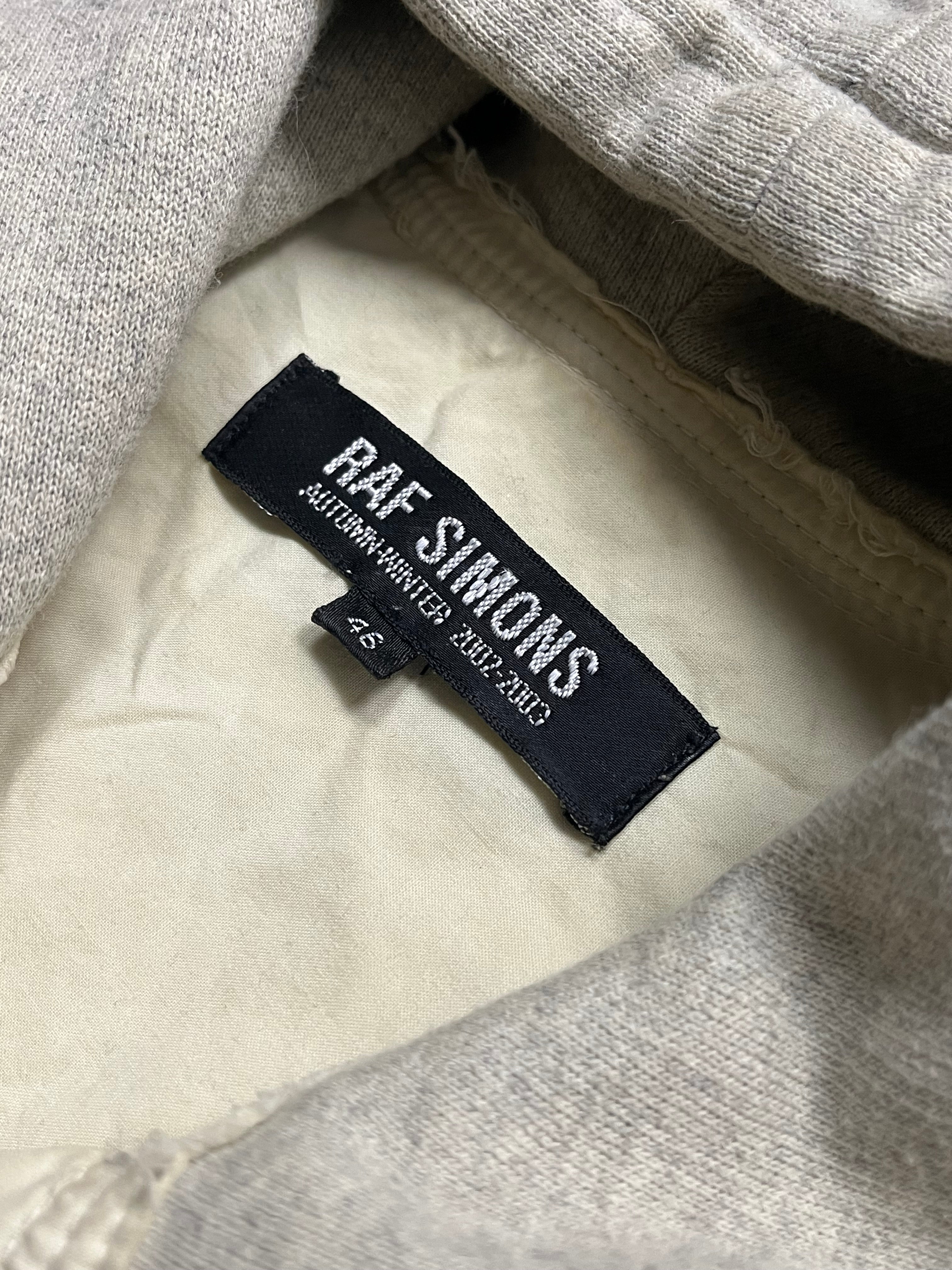 Raf Simons Virginia Creeper deep hooded shirt in dark fabric, featuring a hood and casual style.