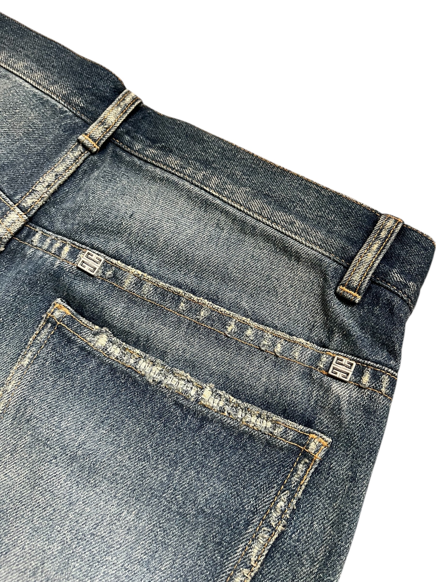 Givenchy FW23 distressed Boro blue denim pants with ripped details and classic five-pocket design.