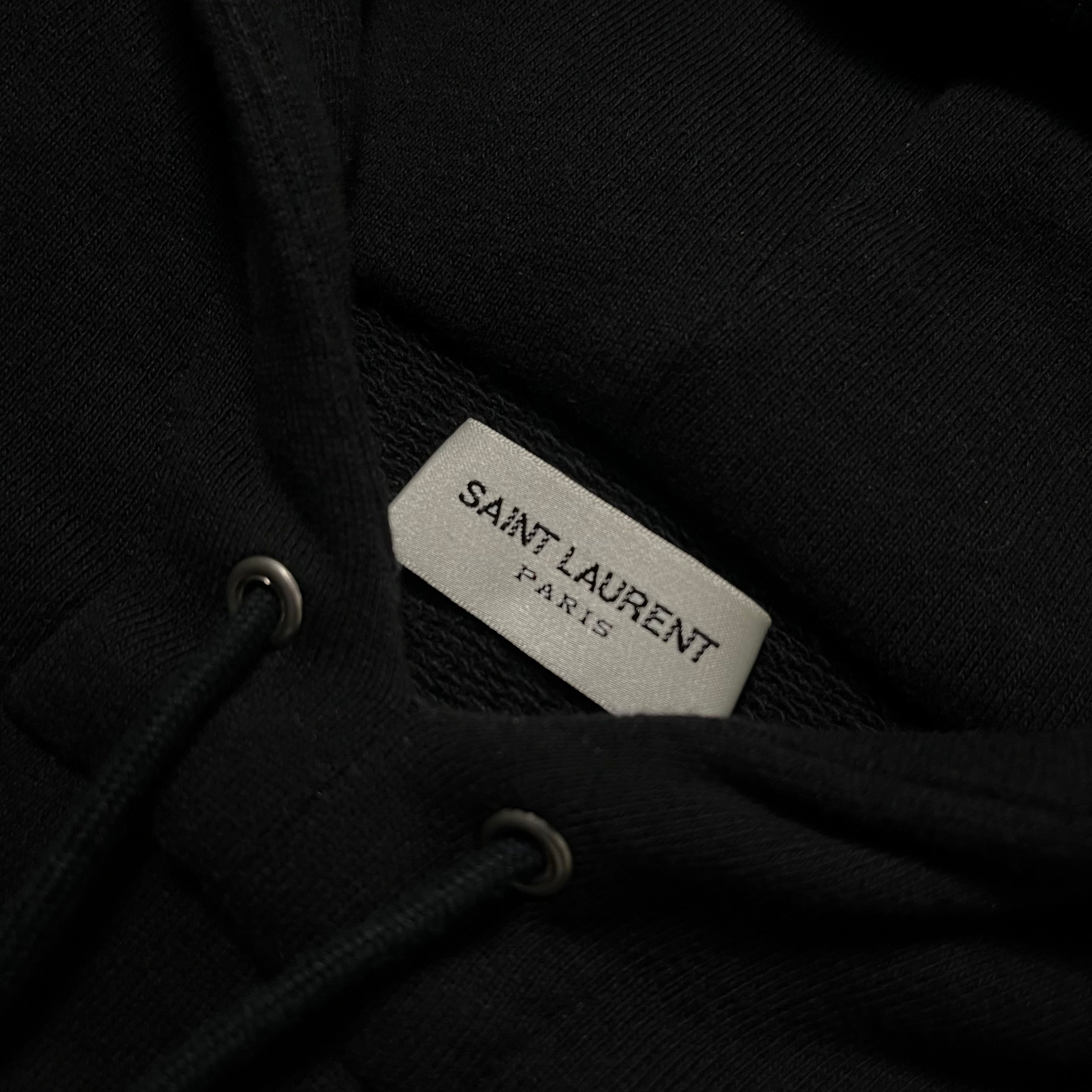 Saint Laurent SS17 small logo hoodie in black, showing the front view with the brand's subtle logo detail on the chest.