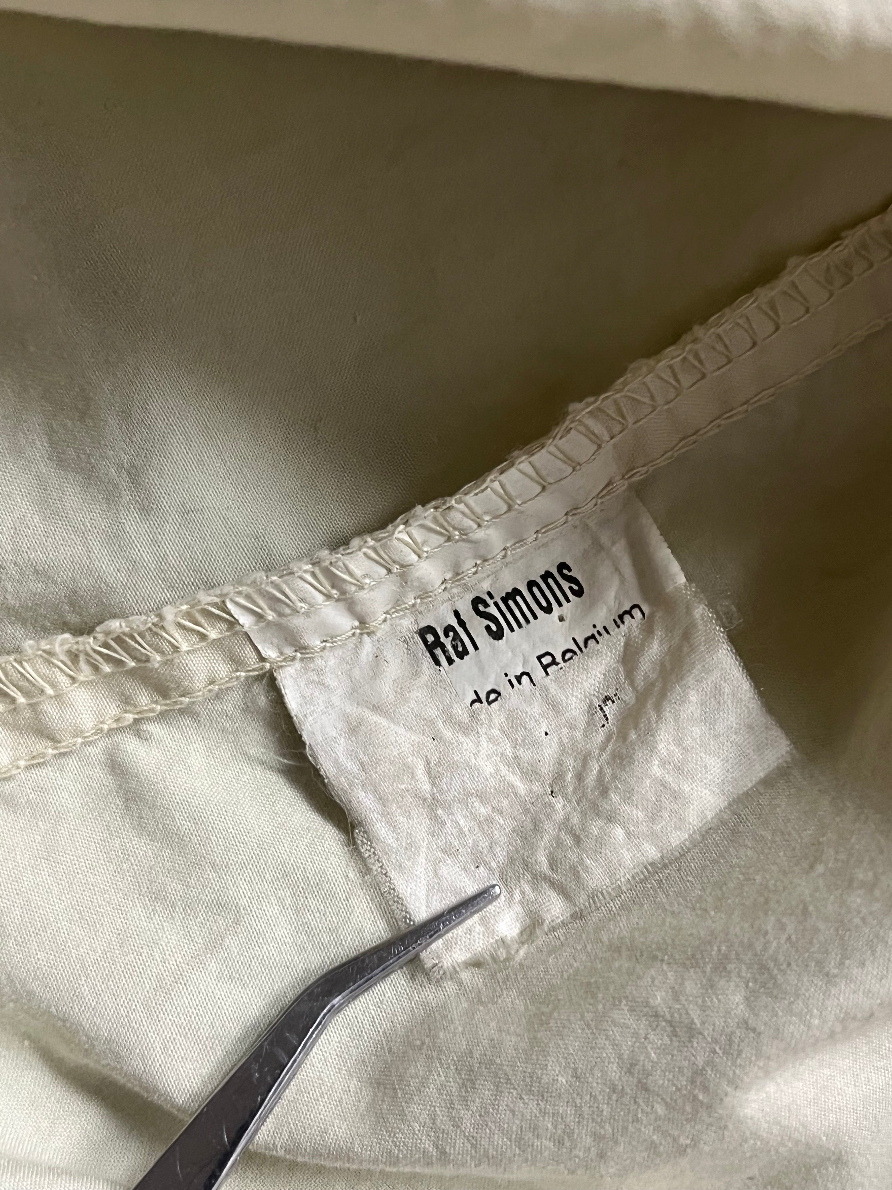 Raf Simons Virginia Creeper deep hooded shirt featuring a dark fabric and hooded design, displayed on a hanger.