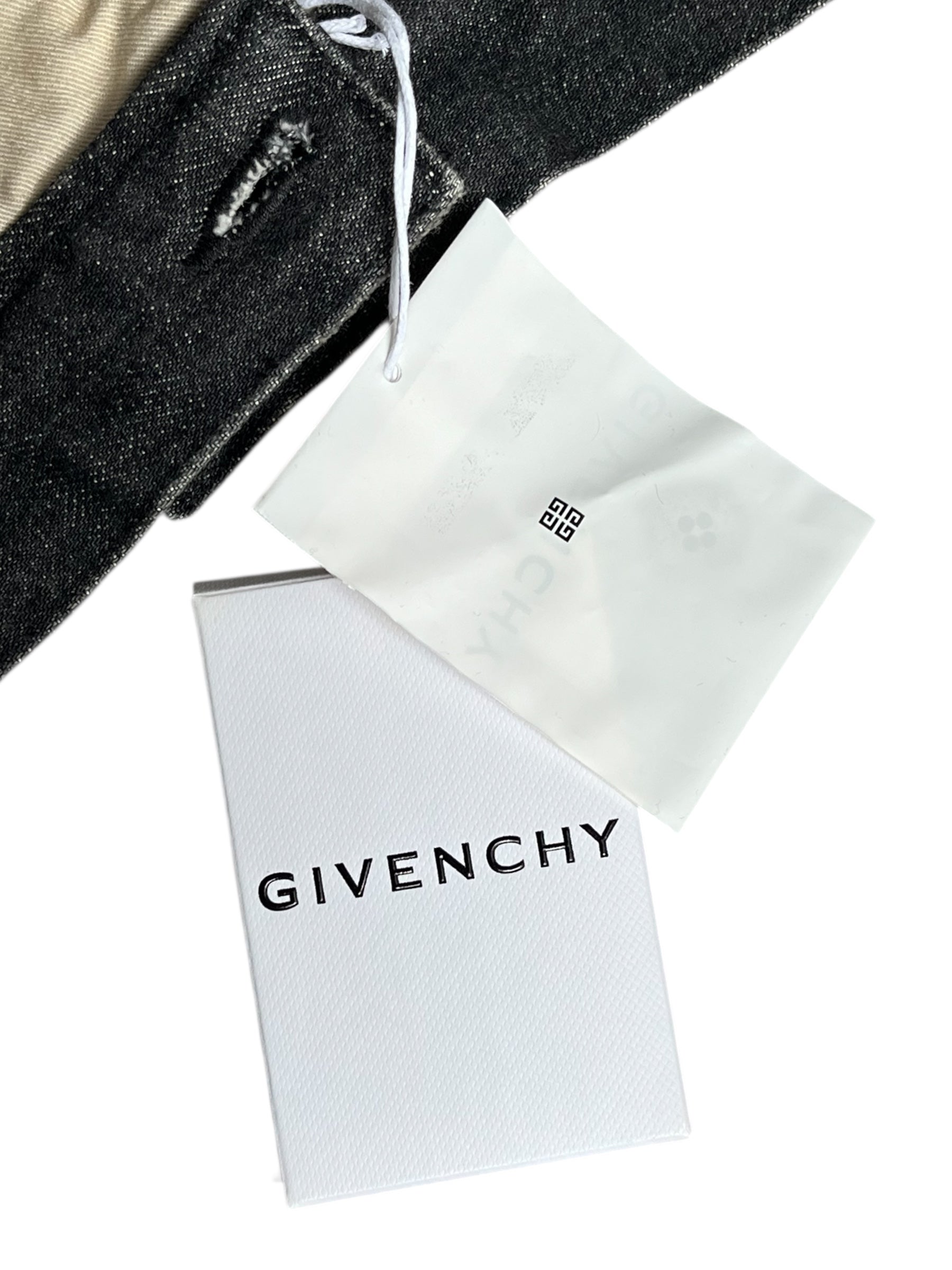 Givenchy FW23 distressed black denim pants with boro-style rips and frayed details, casual fit, front and back view.