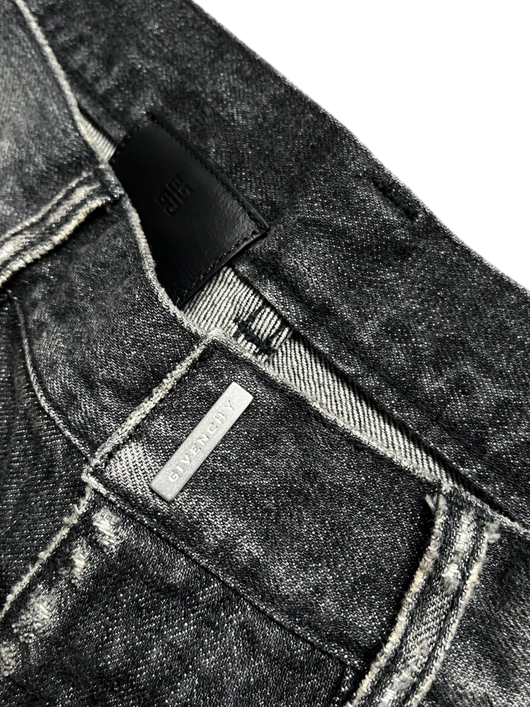 Givenchy FW23 distressed black denim pants with boro-style details and frayed edges, casual and edgy men's pants.