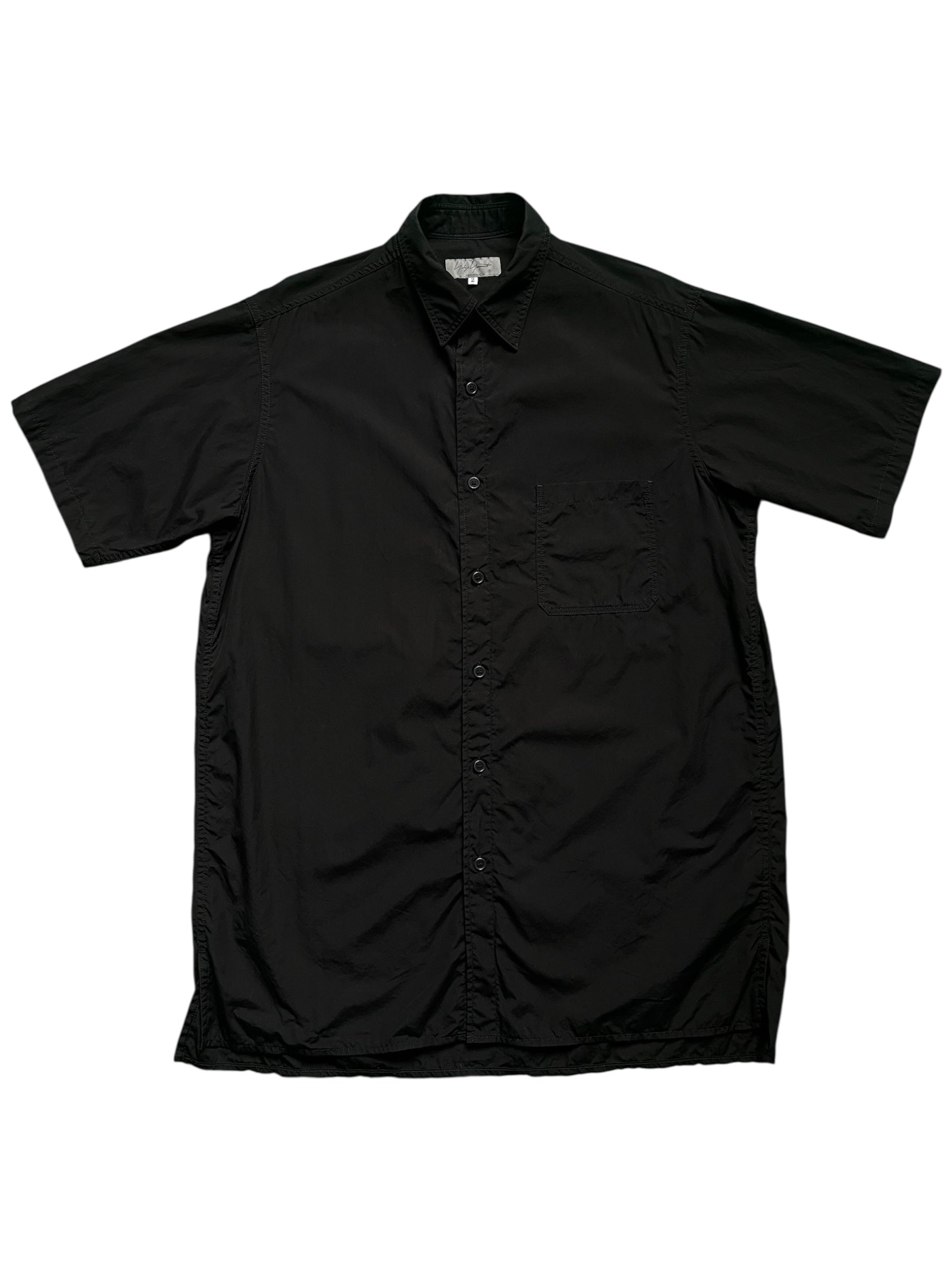 Yohji Yamamoto AW22 black oversized shirt with loose fit and long sleeves, styled on a mannequin.
