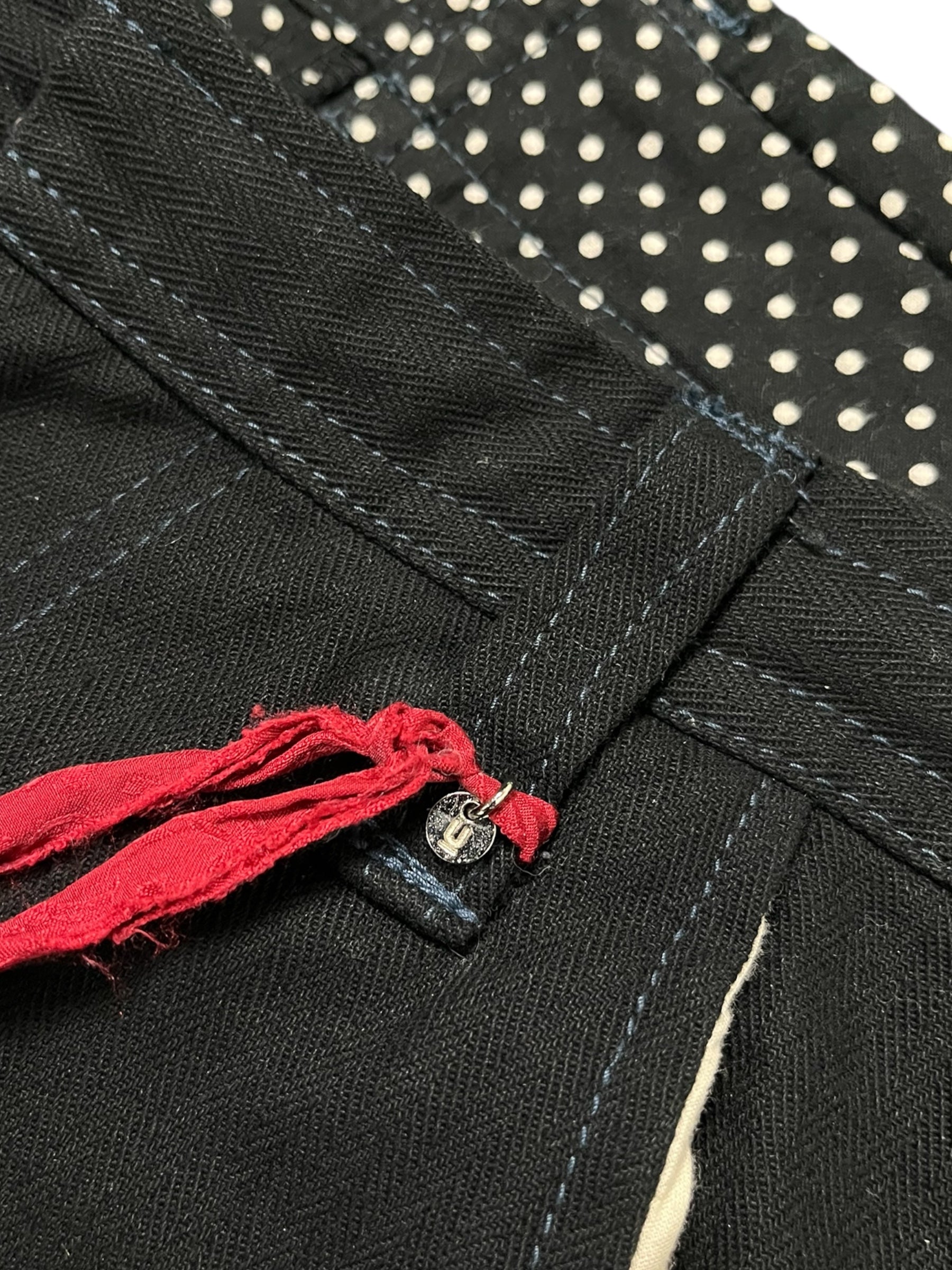Undercover AW04 "But Beautiful" cargo pants featuring parasitic and stuffed details, with a relaxed fit and multiple pockets.