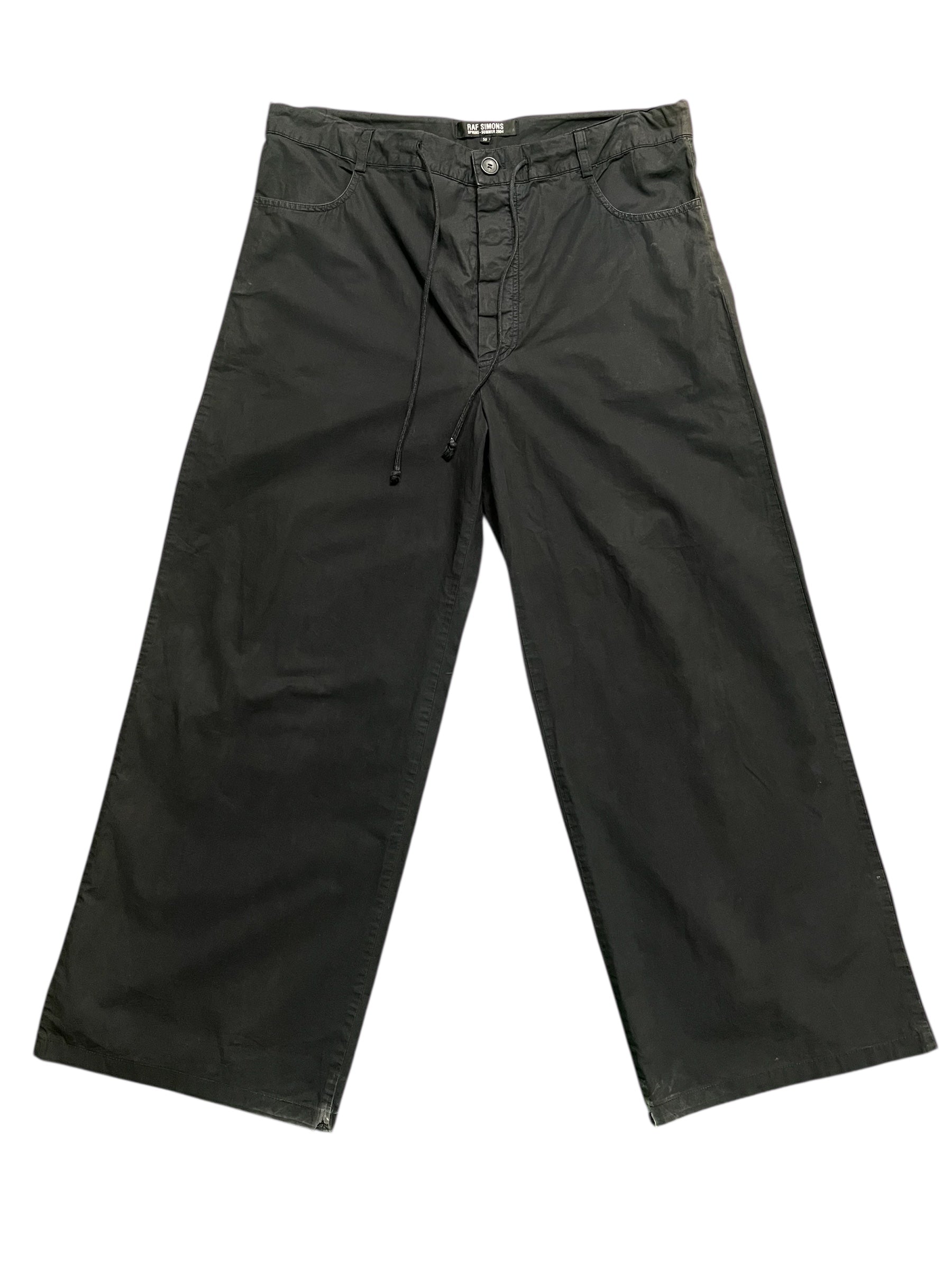 Raf Simons SS04 "May The Circle Be Unbroken" zombie pants featuring distressed fabric and unique design details.