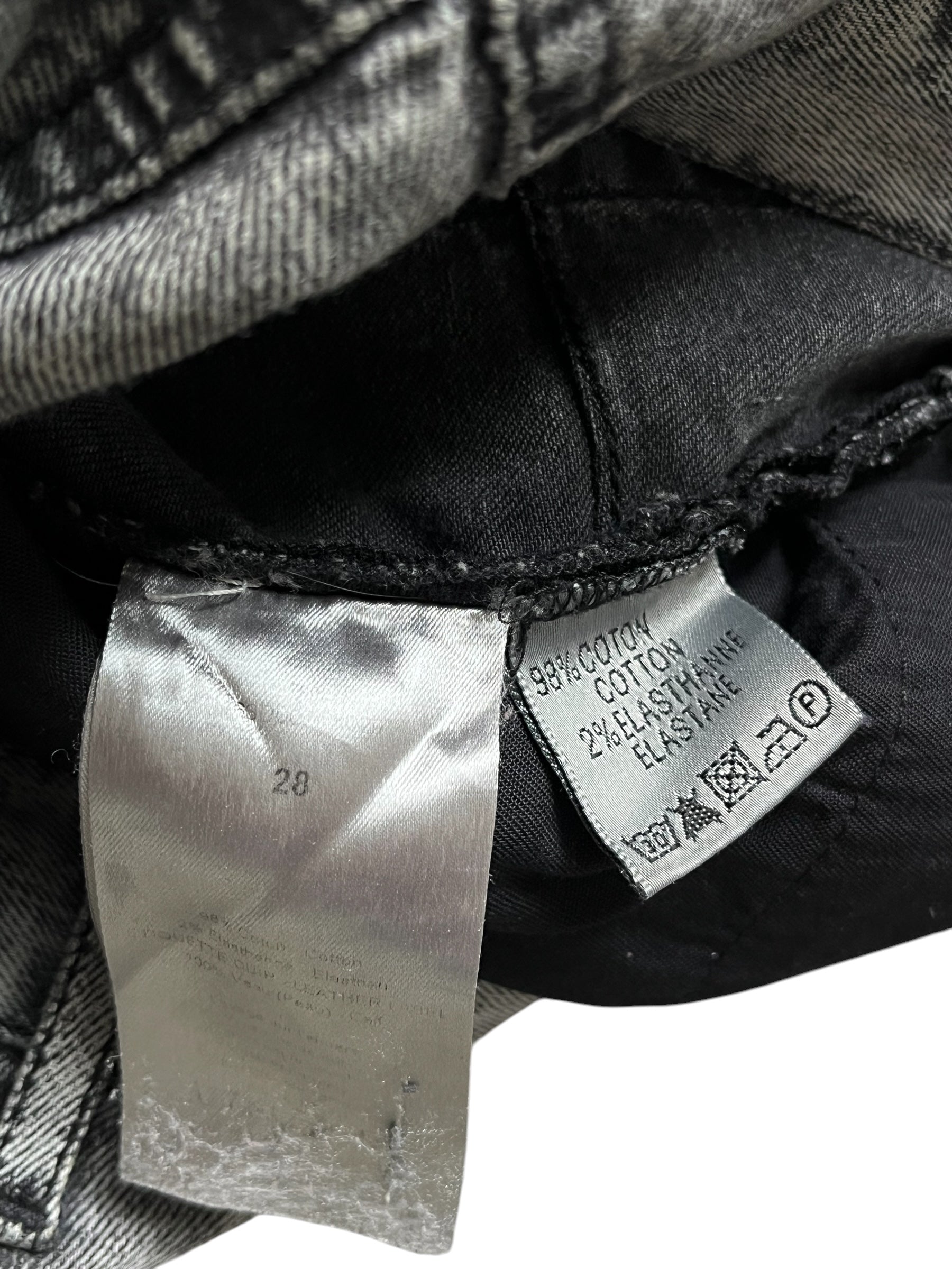 Dior SS15 acid wash slim fit denim pants with distressed detailing and classic five-pocket design on white background.