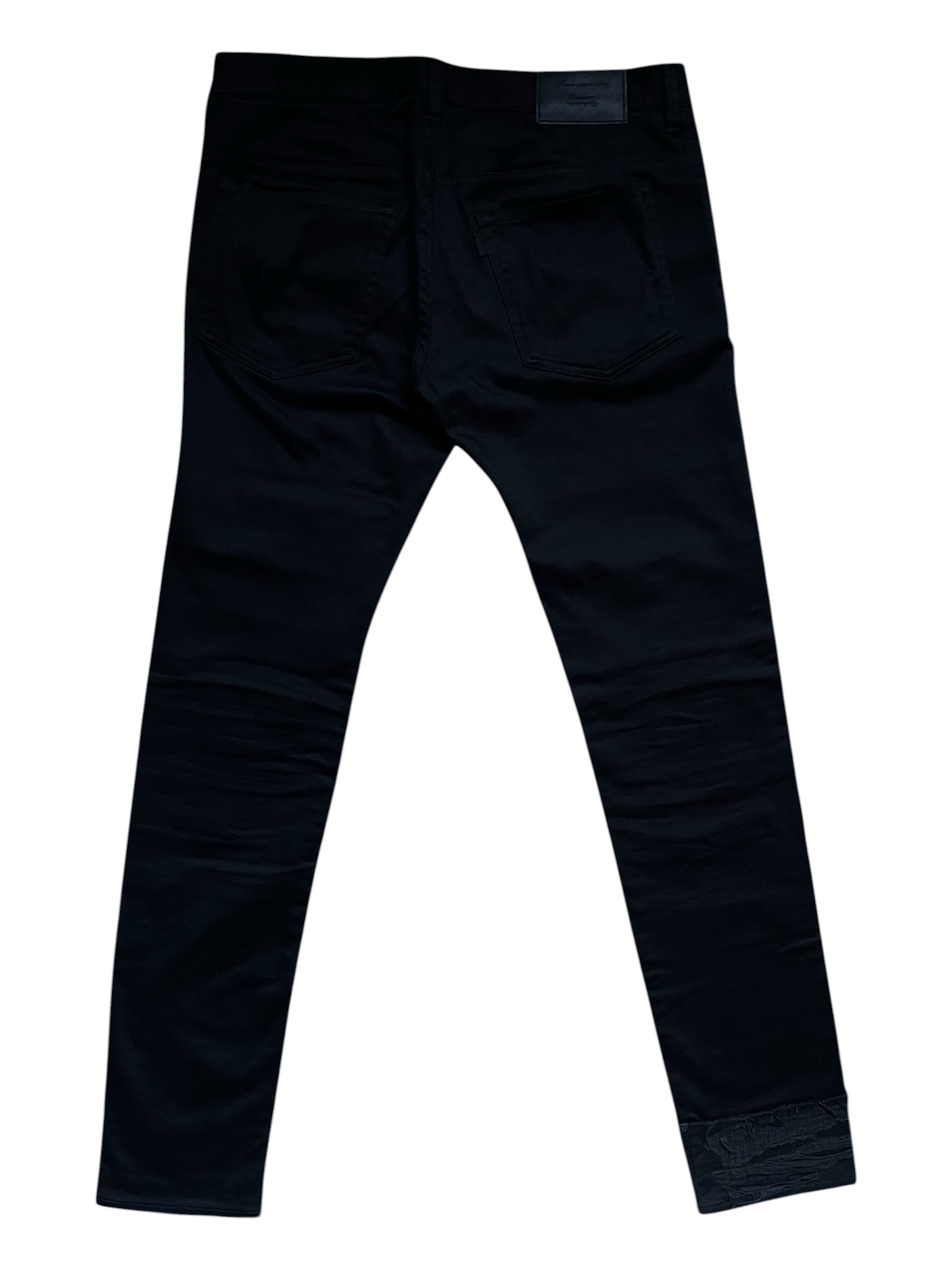 Undercover SS23 Bright Side of the Dark Side SCAB distressed denim jeans with ripped details and a faded, edgy look.